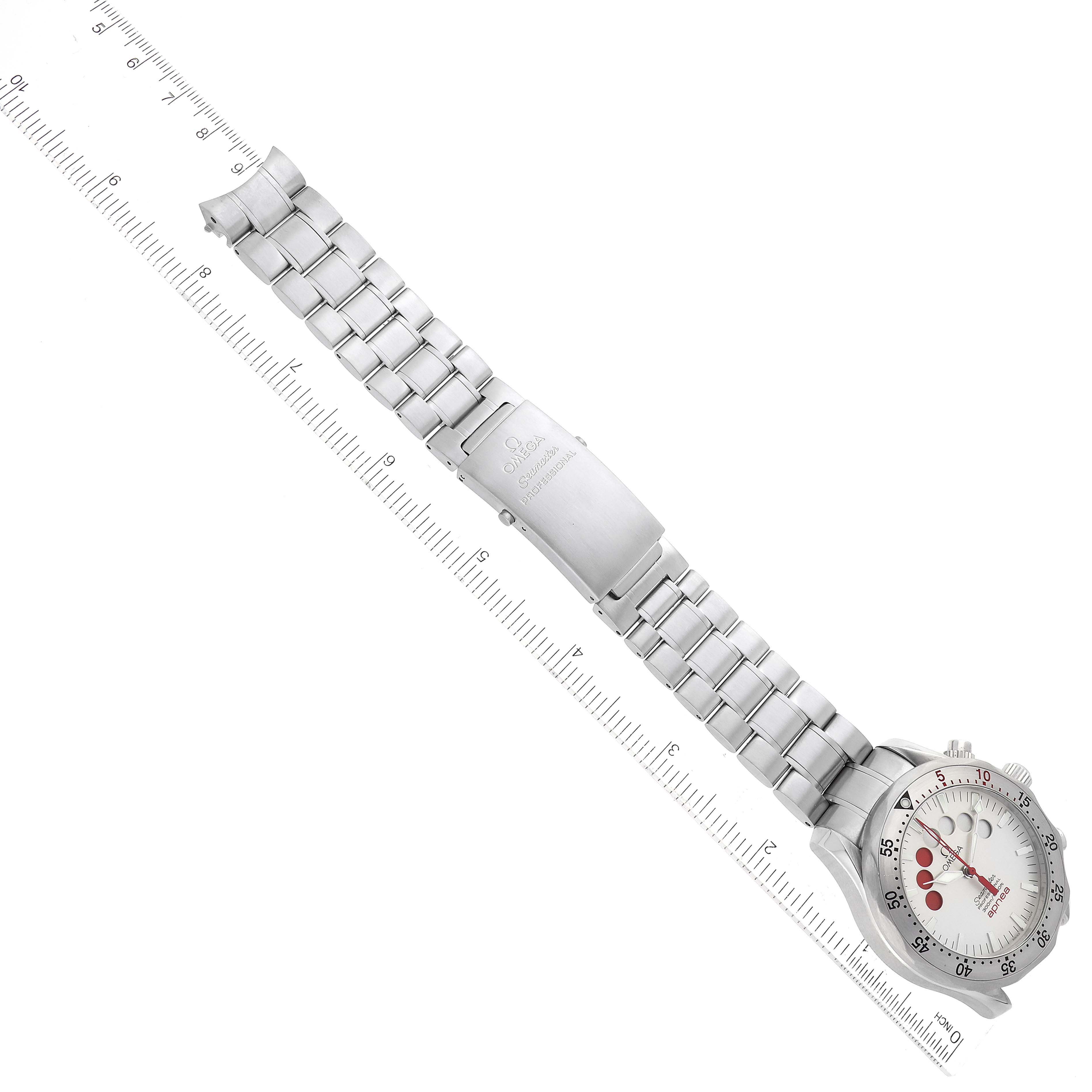 The image shows the front of the Omega Seamaster 2595.30.00 Men
s Stainless Steel Silver Dial 2595.30.00 Men
s Stainless Steel Silver Dial watch laid flat with a ruler for scale.