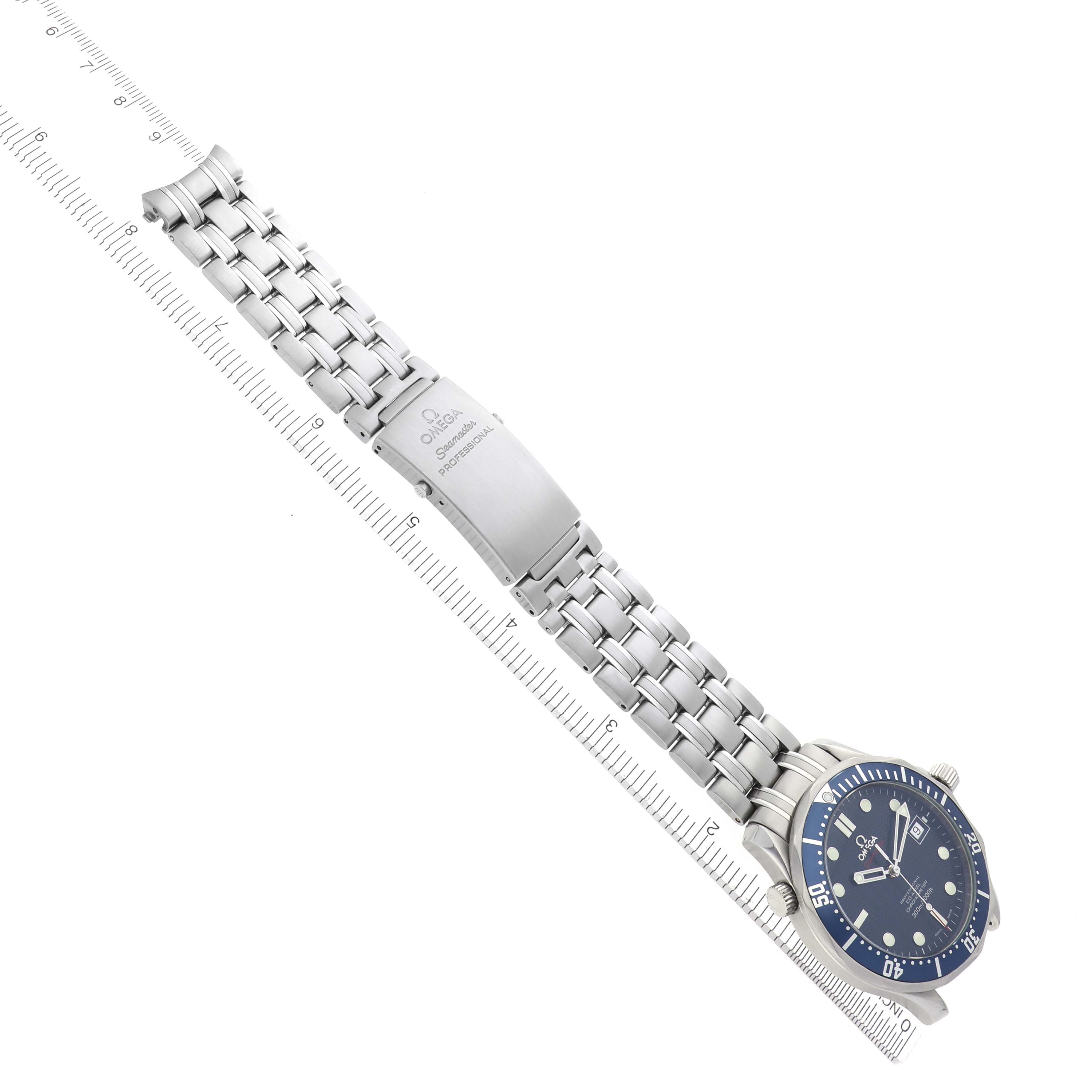 The Omega Seamaster 2220.80.00 Men
s Stainless Steel Blue Dial 2220.80.00 Men
s Stainless Steel Blue Dial watch is shown at an angle displaying the face, bracelet, and clasp, with a ruler for scale.