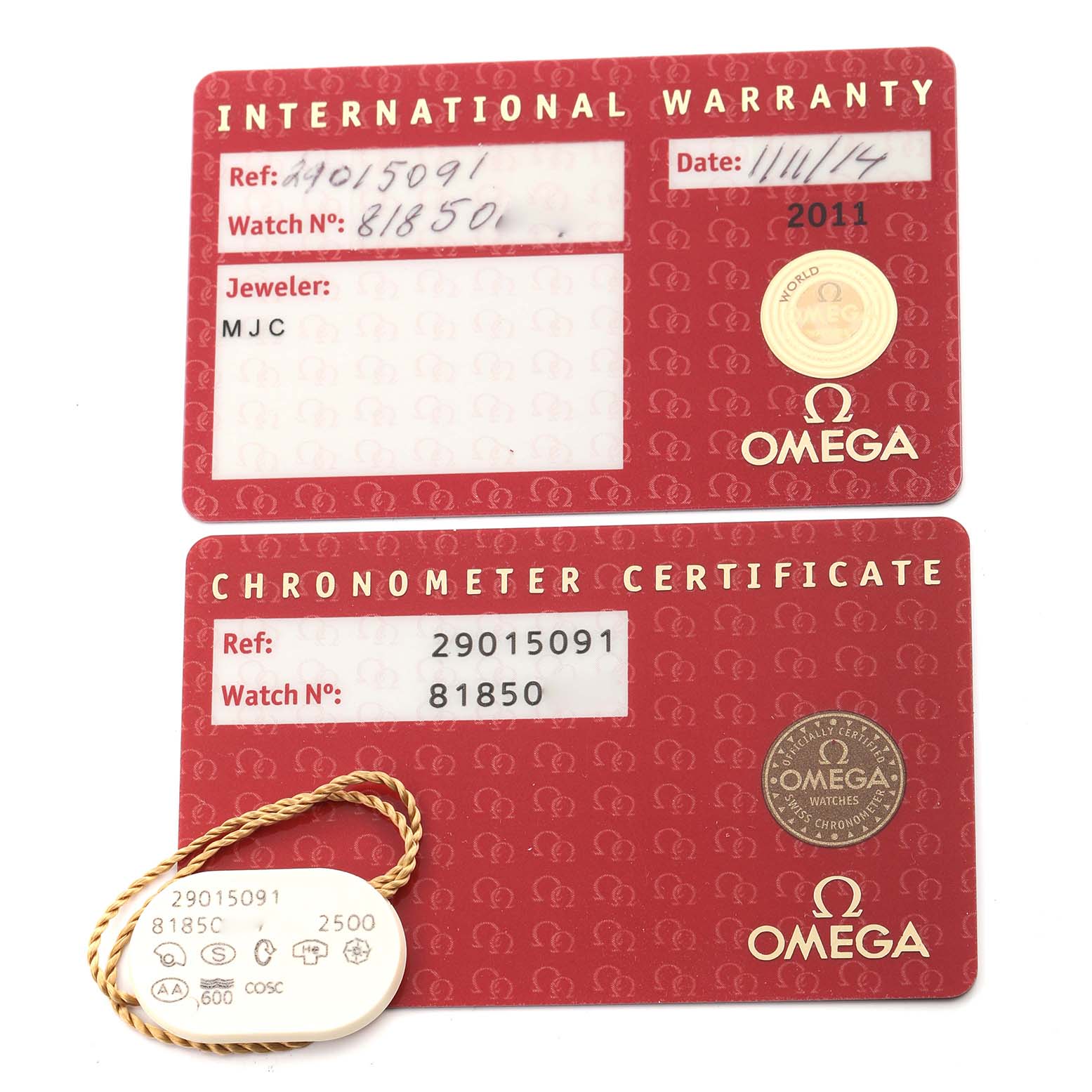 This image shows the International Warranty and Chronometer Certificate cards for the Omega Planet Ocean 2901.50.91 Men
s Stainless Steel Black Dial 2901.50.91 Men
s Stainless Steel Black Dial watch, along with a tag.