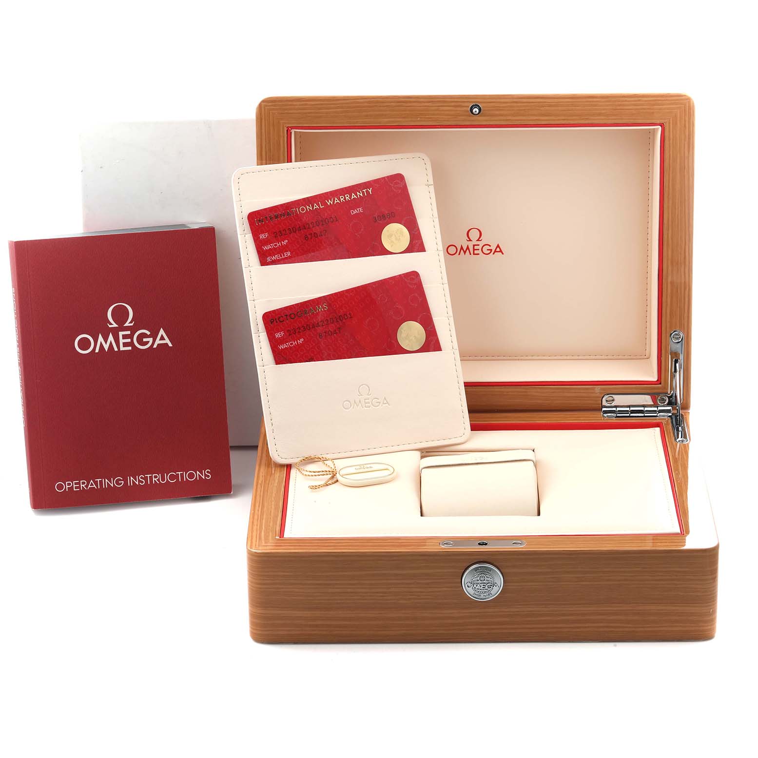 The image shows a Planet Ocean Omega watch box, operating instructions, warranty and pictogram cards at a straight angle.