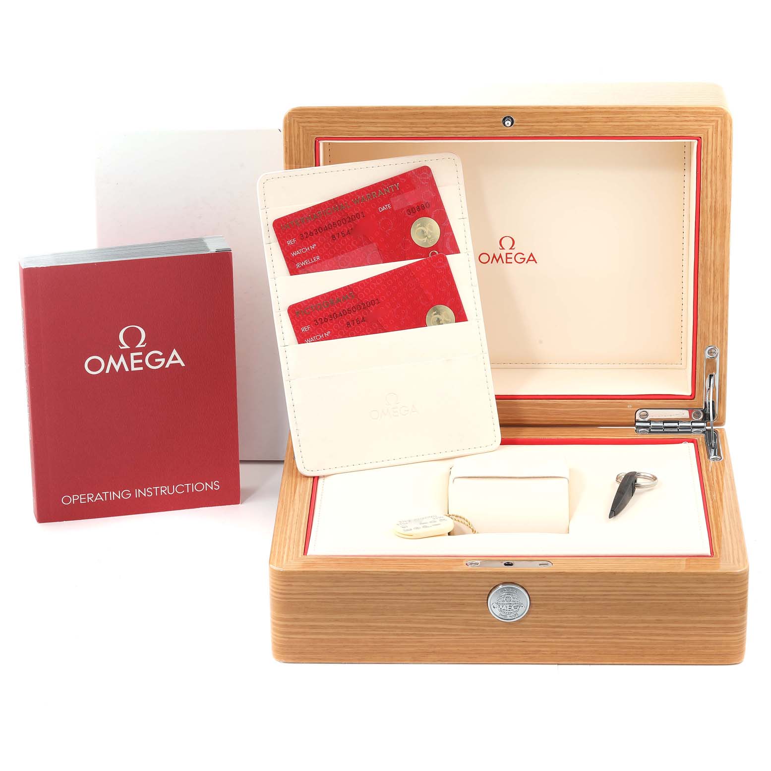 This image shows a wooden Omega Speedmaster 326.30.40.50.02.001 Men's Stainless Steel Silver Dial 326.30.40.50.02.001 Men's Stainless Steel Silver Dial box, operating instructions, warranty cards, and watch accessories.