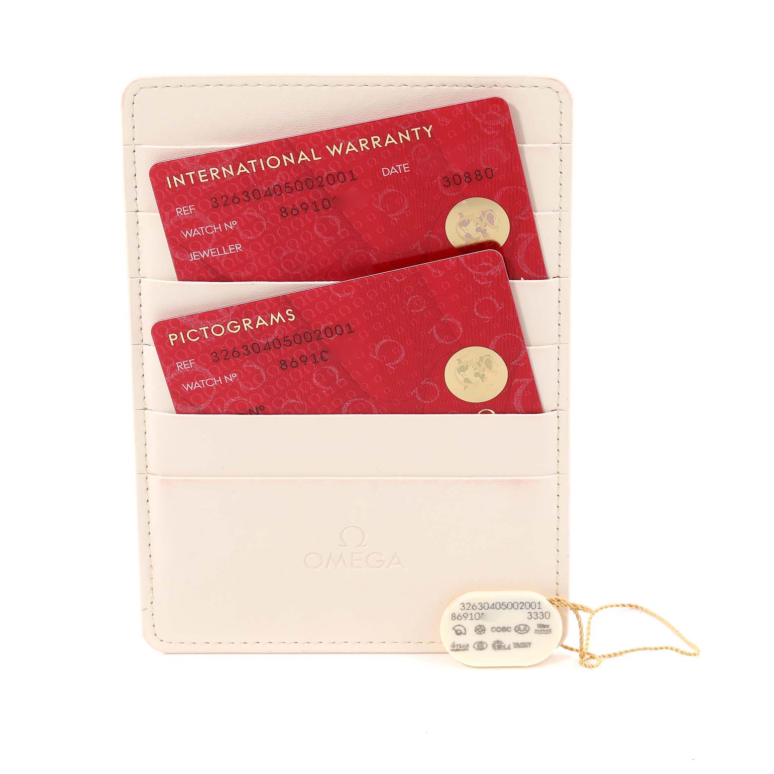 The image shows an Omega Speedmaster 326.30.40.50.02.001 Men's Stainless Steel Silver Dial 326.30.40.50.02.001 Men's Stainless Steel Silver Dial warranty and pictogram cards, along with a tag, placed in a cream-colored card holder.