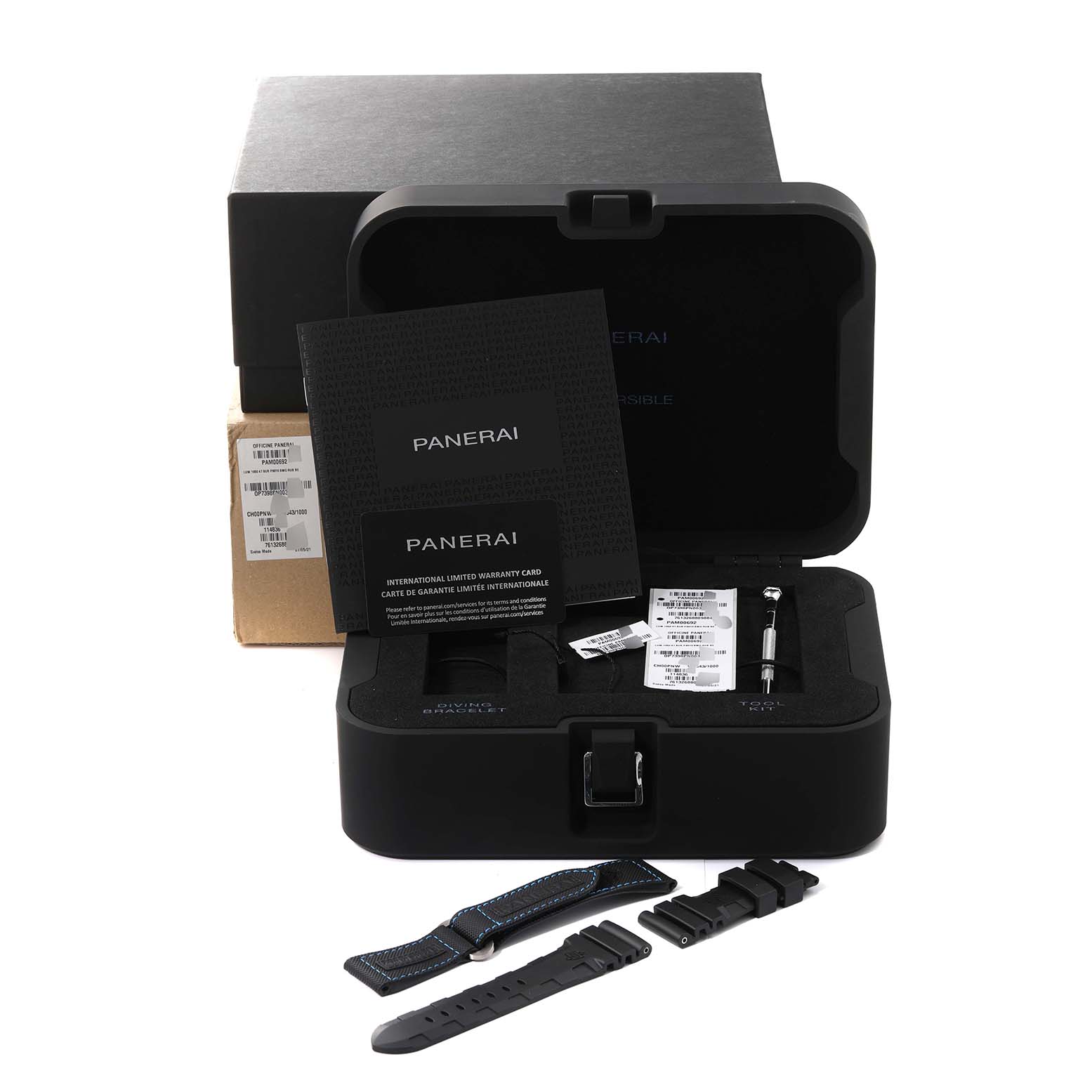 The Panerai Submersible PAM00692 Men
s Titanium Blue Dial PAM00692 Men
s Titanium Blue Dial watch accessories are shown from a frontal angle, including the box, warranty card, extra straps, and tools.