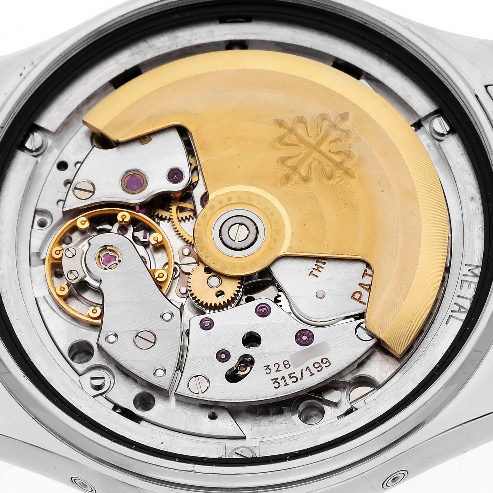 The image shows the intricate movement and mechanism of a Patek Philippe Complications 5036/1 Men
s White Gold Silver Dial 5036/1 Men
s White Gold Silver Dial model watch from the back.