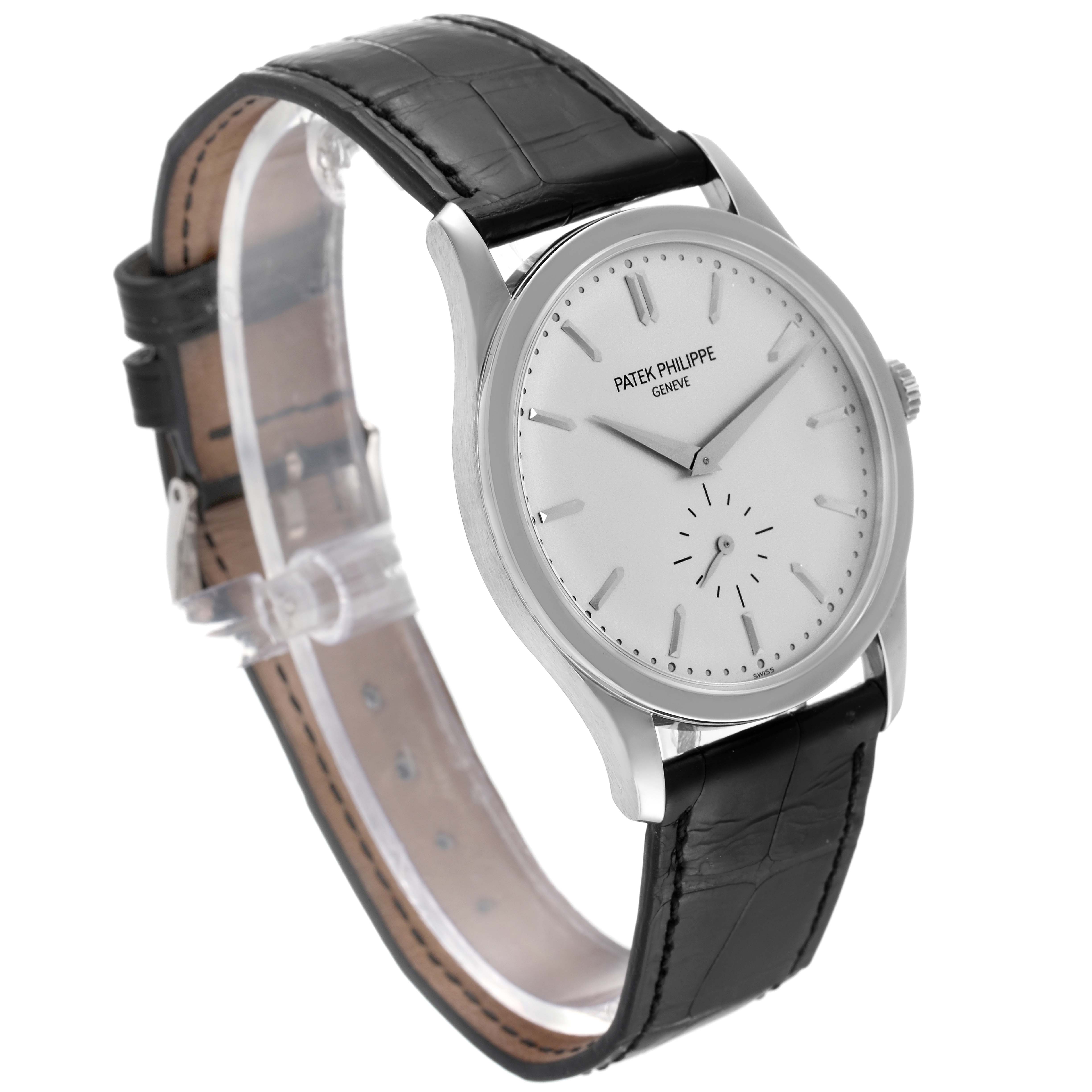 The image shows a Patek Philippe Calatrava 5196G Men
s White Gold Silver Dial 5196G Men
s White Gold Silver Dial watch from a diagonal front angle, displaying its face, crown, and black leather strap.