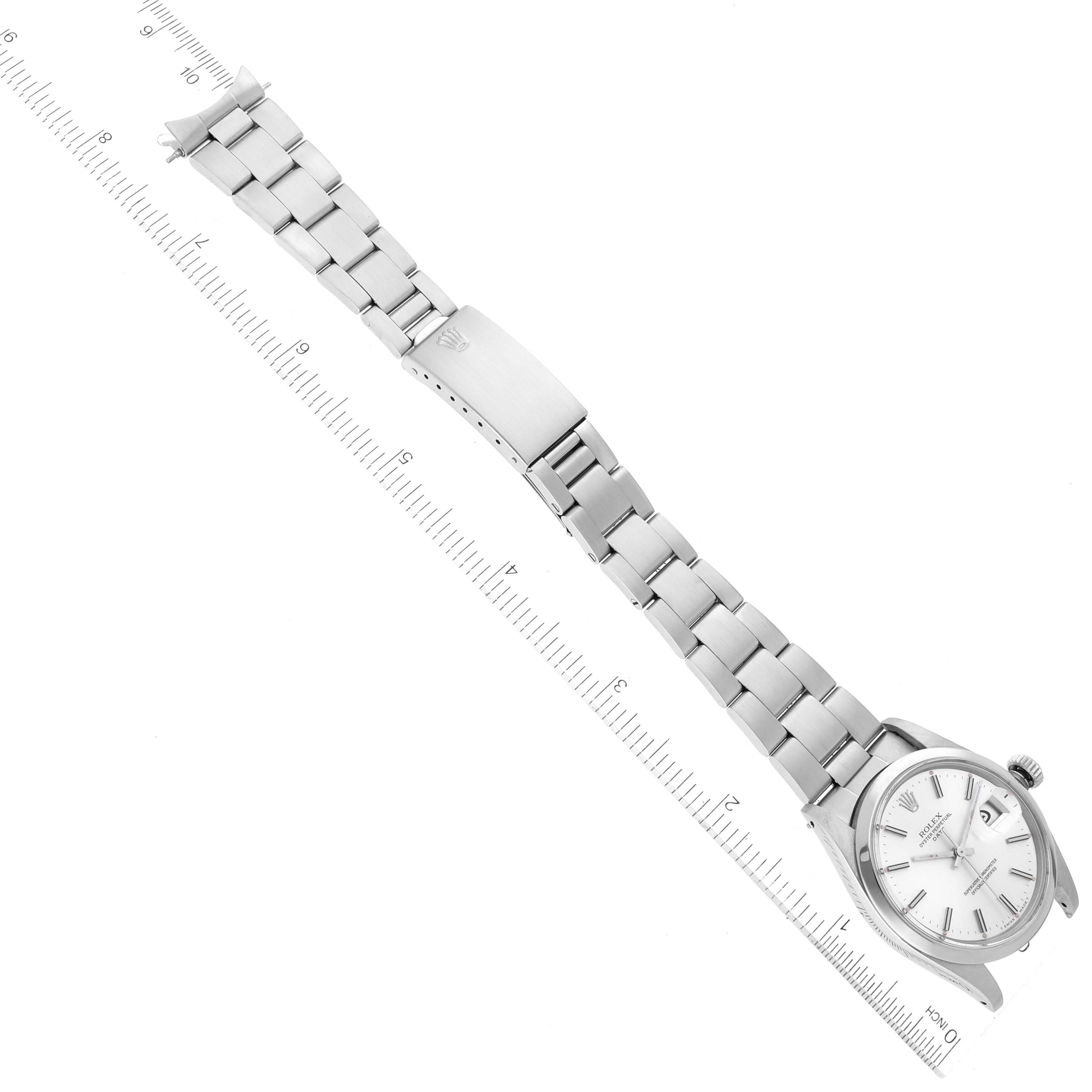 The Rolex Vintage Collection 1500 Men's Stainless Steel Silver Dial 1500 Men's Stainless Steel Silver Dial watch is displayed flat with a focus on the dial, bracelet, and clasp, along with a ruler for scale.