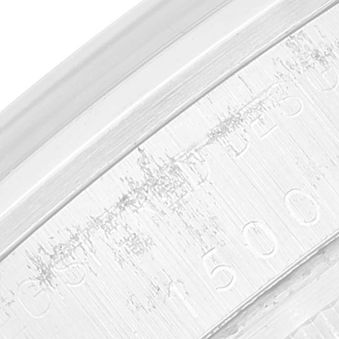 This close-up image shows the edge markings and texture on the back casing of a Rolex Vintage Collection 1500 Men's Stainless Steel Silver Dial 1500 Men's Stainless Steel Silver Dial watch.