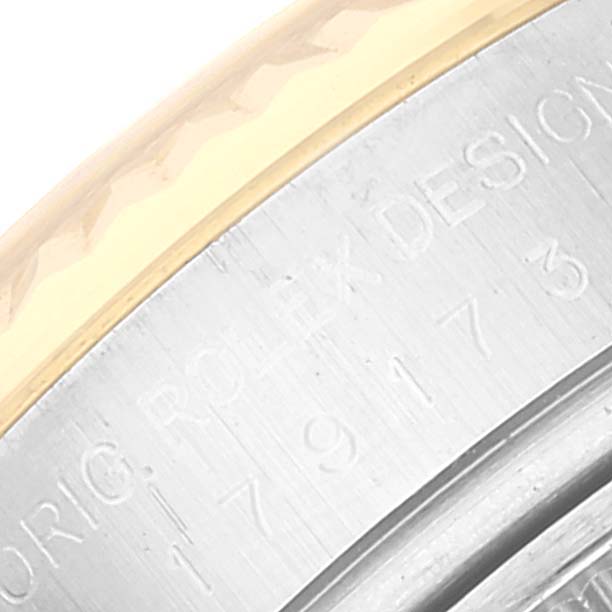 The image shows a close-up of the bezel and part of the engraving on the side of a Rolex Datejust 179173 Women's Steel and Gold (two tone) Champagne Dial 179173 Women's Steel and Gold (two tone) Champagne Dial watch.