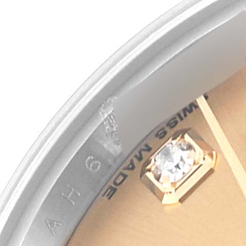 This close-up image of the Rolex Datejust 179173 Women's Steel and Gold (two tone) Champagne Dial 179173 Women's Steel and Gold (two tone) Champagne Dial watch shows a segment of the dial, with "SWISS MADE" text and a diamond marker.