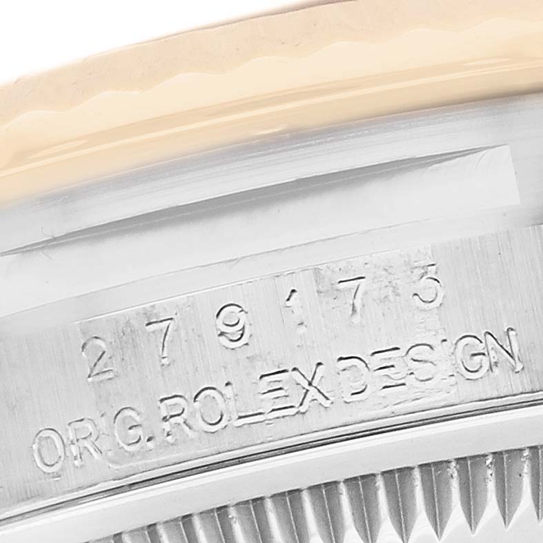 The image shows a close-up of the side of a Rolex Datejust 279173 Women's Steel and Gold (two tone) Silver Dial 279173 Women's Steel and Gold (two tone) Silver Dial watch with engraved serial numbers and "ORIG ROLEX DESIGN" text.