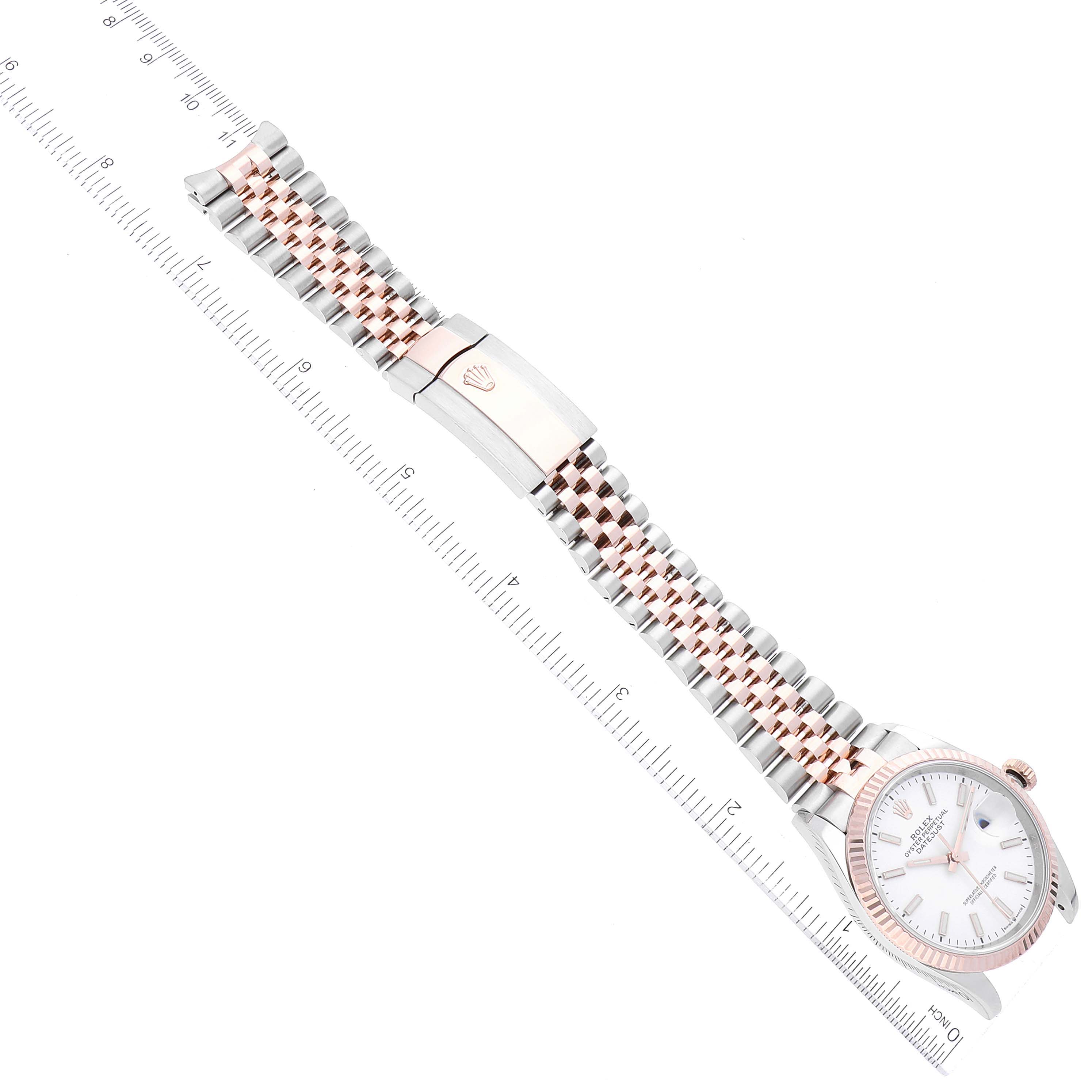 The image shows a top-down view of a Rolex Datejust 126231 Men's Steel and Gold (two tone) White Dial 126231 Men's Steel and Gold (two tone) White Dial watch, highlighting its dial, bezel, and two-tone bracelet with a clasp.