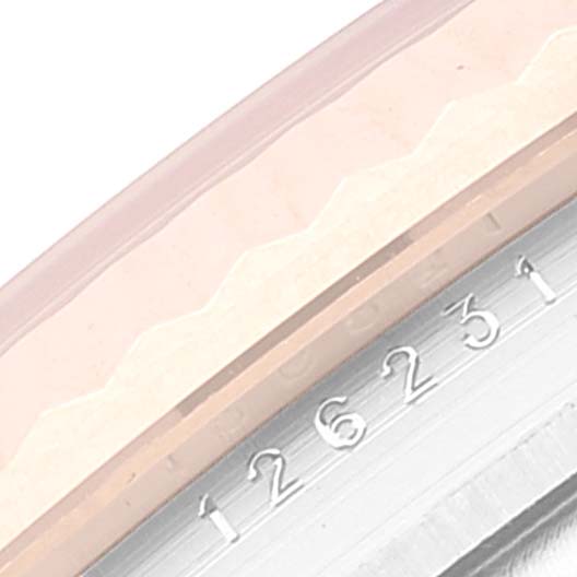 This image shows a close-up of the fluted bezel and case side of a Rolex Datejust 126231 Men's Steel and Gold (two tone) White Dial 126231 Men's Steel and Gold (two tone) White Dial, displaying part of the serial number.