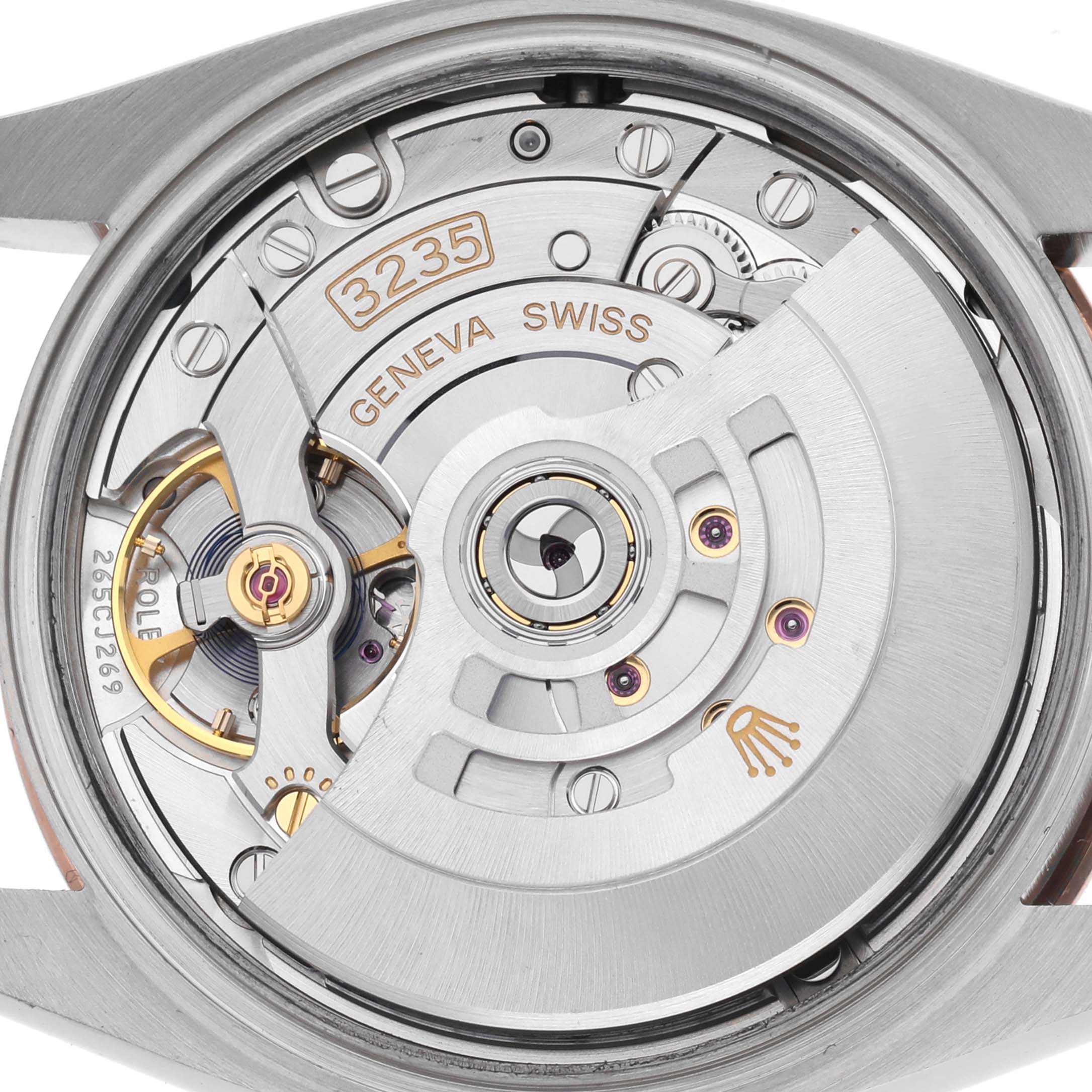 The image shows the movement of a Rolex Datejust 126201 Men's Steel and Gold (two tone) White Dial 126201 Men's Steel and Gold (two tone) White Dial watch from the back, highlighting its intricate mechanical details.