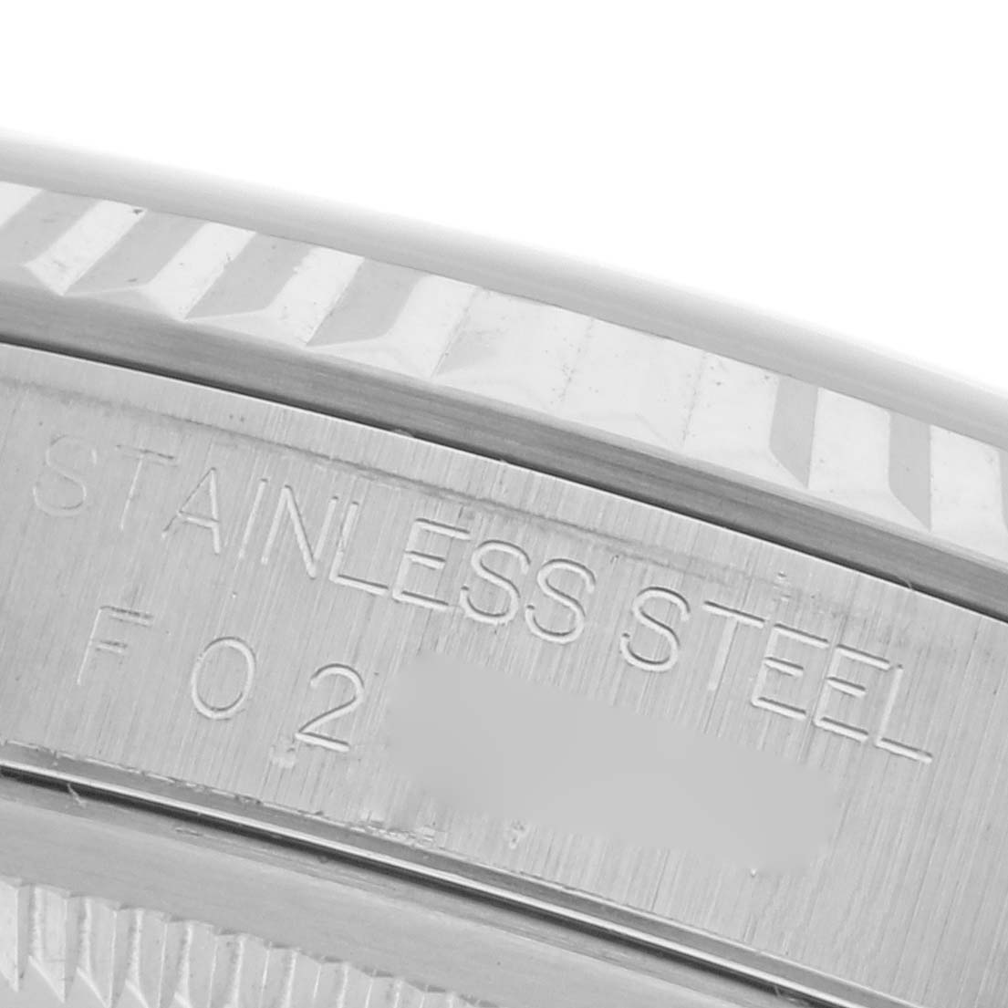 The image shows a close-up of the Rolex Datejust 16234 Men's Stainless Steel Pink Dial 16234 Men's Stainless Steel Pink Dial model's stainless steel outer case with engraved details.