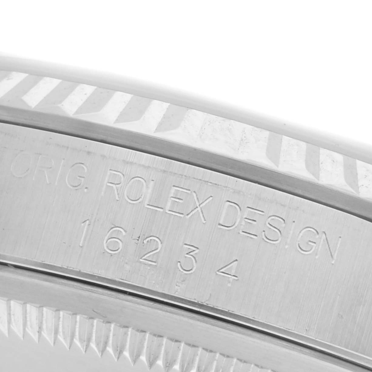 The image shows a close-up of the edge and side engraving of a Rolex Datejust 16234 Men's Stainless Steel Pink Dial 16234 Men's Stainless Steel Pink Dial watch bezel with model number.