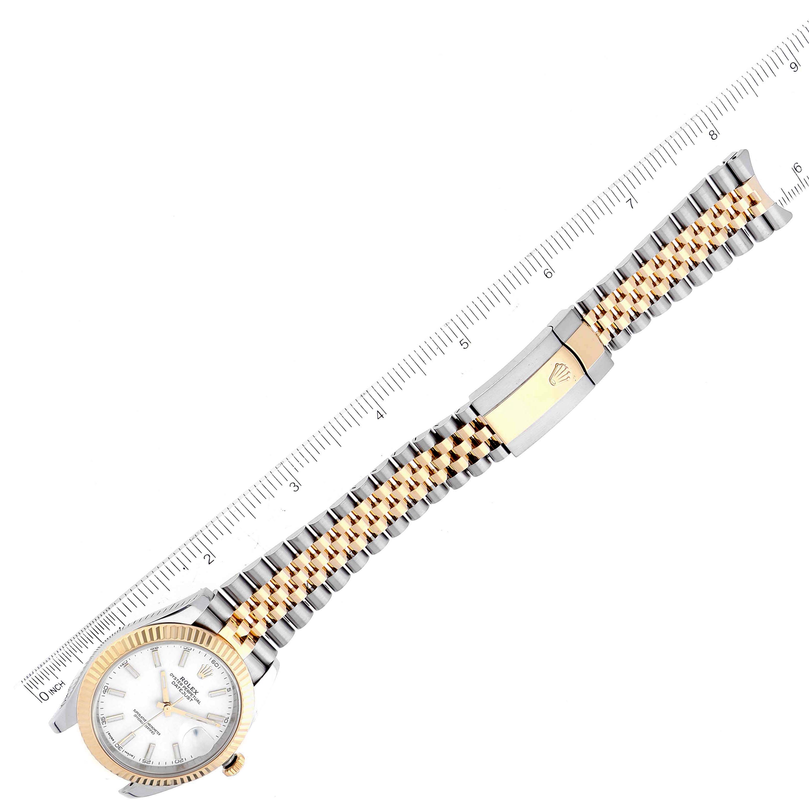 A Rolex Datejust 41 126333 Men's Steel and Gold (two tone) White Dial 126333 Men's Steel and Gold (two tone) White Dial is shown from an overhead angle, displaying its face, bezel, and full bracelet with a ruler for scale.