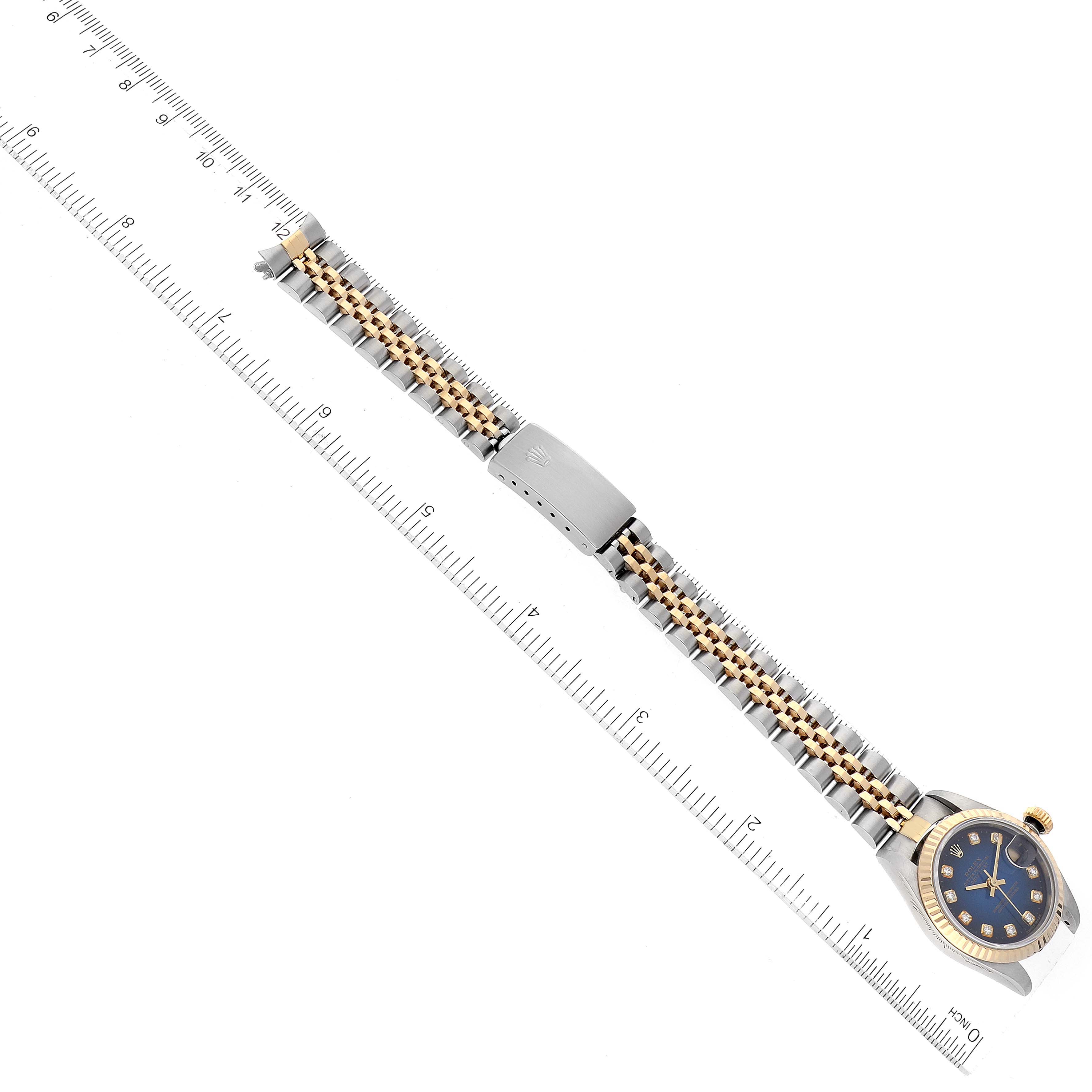 The image shows a top-down view of a Rolex Datejust 69173 Women's Steel and Gold (two tone) Blue Dial 69173 Women's Steel and Gold (two tone) Blue Dial watch, focusing on its bracelet and part of the watch face alongside a ruler.