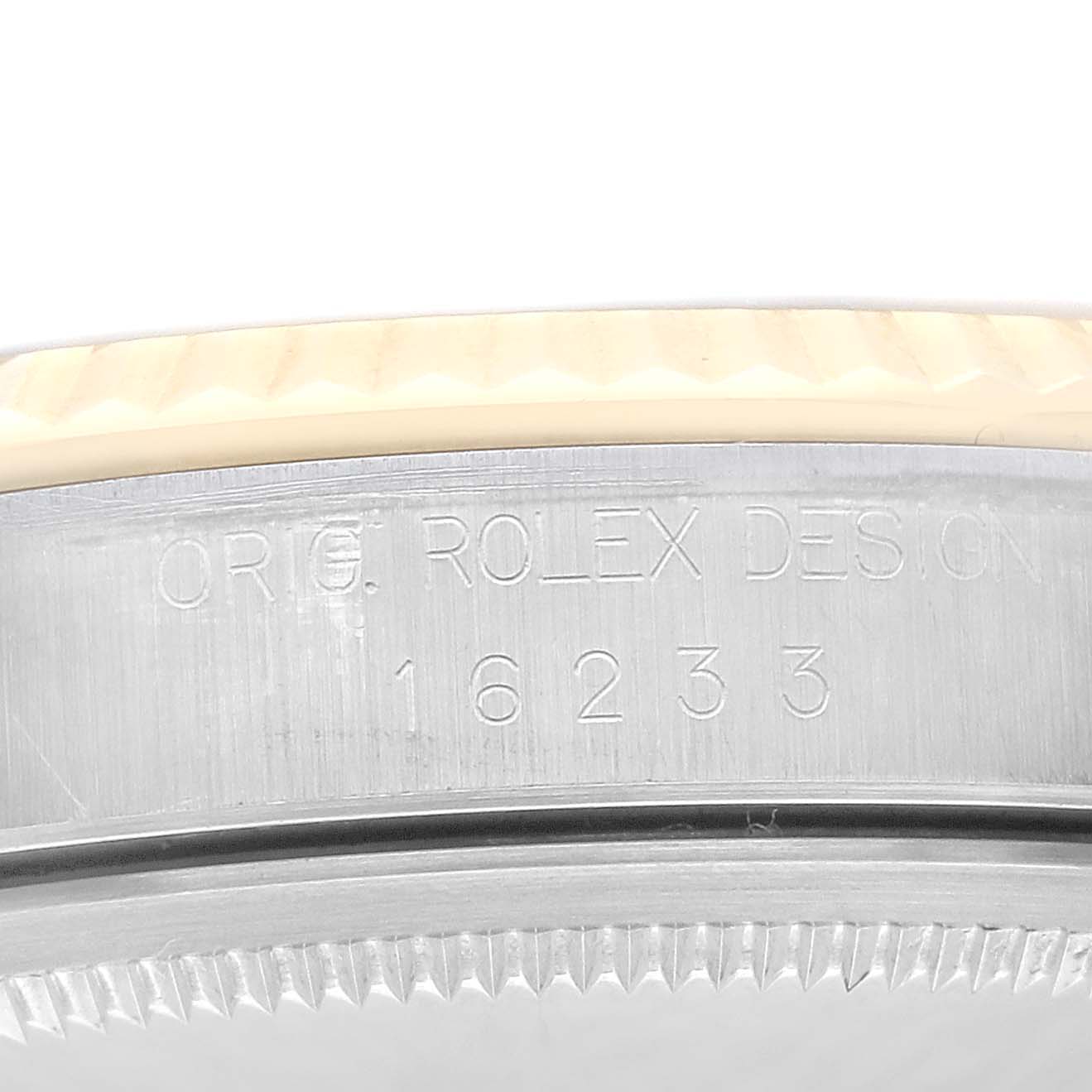 This is a close-up of the case side of a Rolex Datejust 16233 Men's Steel and Gold (two tone) Champagne Dial 16233 Men's Steel and Gold (two tone) Champagne Dial, showing the model number and design engraving.