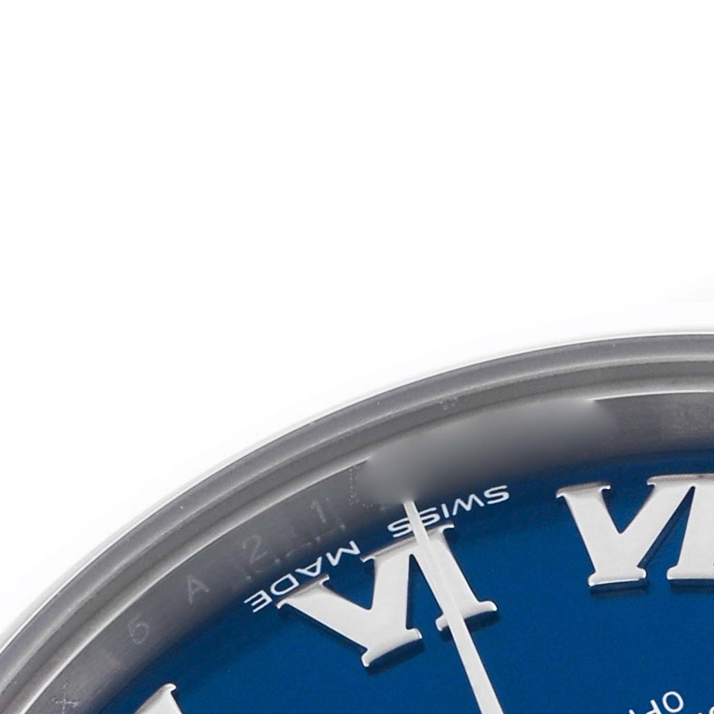 The image shows a close-up of a Rolex Mid-Size 178240 Women's Stainless Steel Blue Dial 178240 Women's Stainless Steel Blue Dial watch, focusing on the edge of the blue dial with Roman numerals and the "Swiss Made" text.