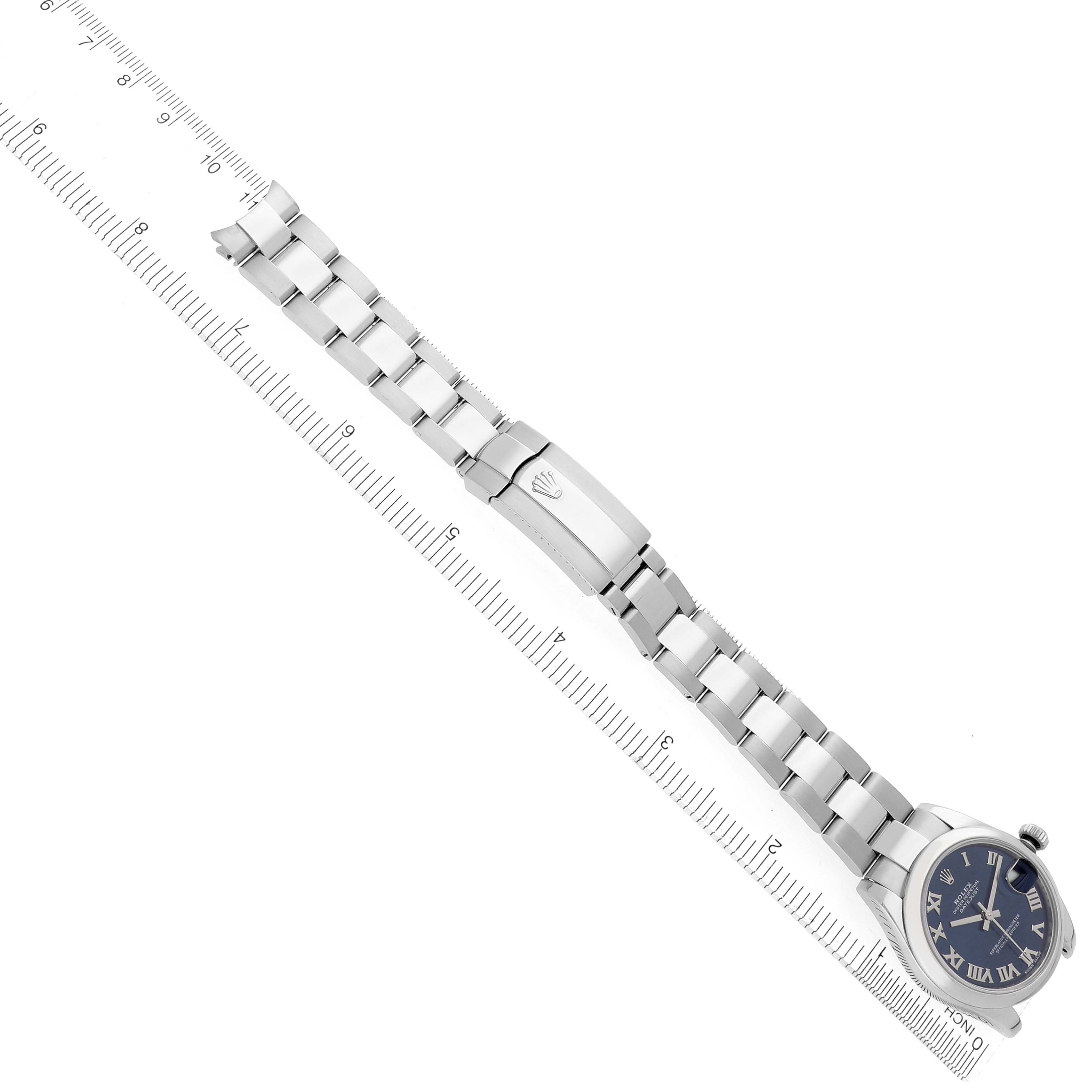 The Rolex Mid-Size 178240 Women's Stainless Steel Blue Dial 178240 Women's Stainless Steel Blue Dial watch is shown diagonally, displaying the face, bracelet, and clasp next to a ruler for scale.