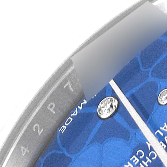 This is a close-up angle showing part of the dial and bezel of a Rolex Mid-Size 278274 Women's Stainless Steel Blue Dial 278274 Women's Stainless Steel Blue Dial watch.