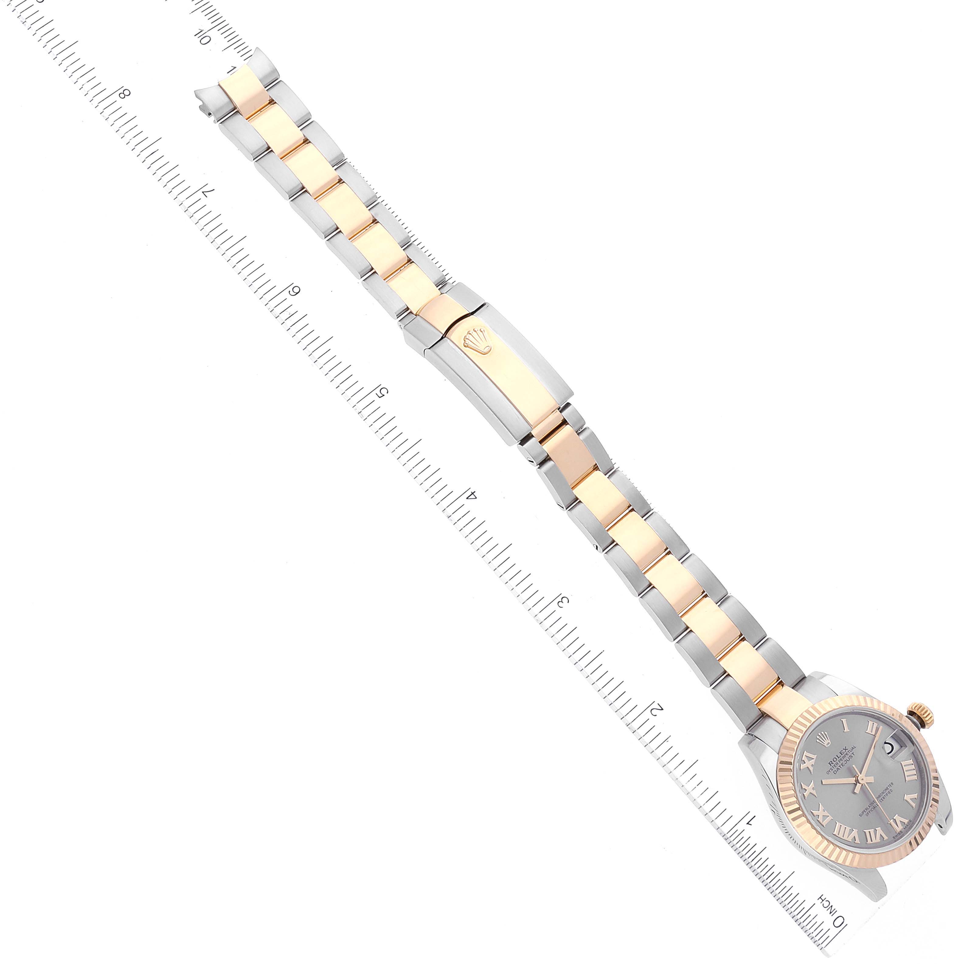 The image shows a Mid-Size Rolex watch laid flat, featuring its bracelet, clasp, and face at an angled view.