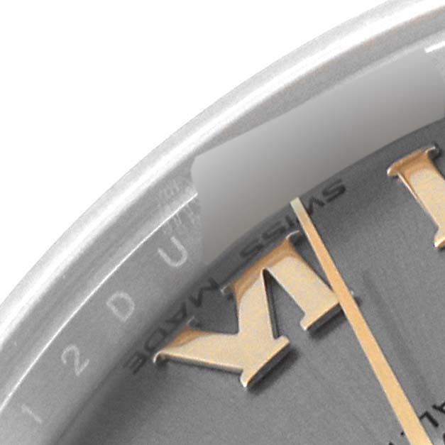 This close-up of a Rolex Mid-Size 178273 Women
s Steel and Gold (two tone) Grey Dial 178273 Women
s Steel and Gold (two tone) Grey Dial watch shows part of the dial with hour markers and the edge of the case.