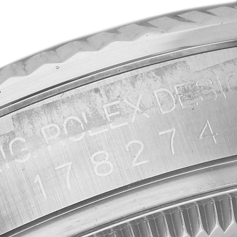 This image shows a close-up of the bezel and engraved serial number of a Rolex Mid-Size 178274 Women's Stainless Steel Pink Dial 178274 Women's Stainless Steel Pink Dial watch.