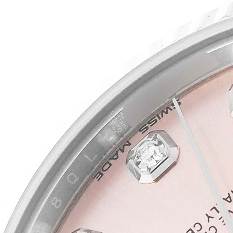 The image shows a close-up of the dial and bezel of a Rolex Mid-Size 178274 Women's Stainless Steel Pink Dial 178274 Women's Stainless Steel Pink Dial watch, highlighting a diamond marker and the text "SWISS MADE."