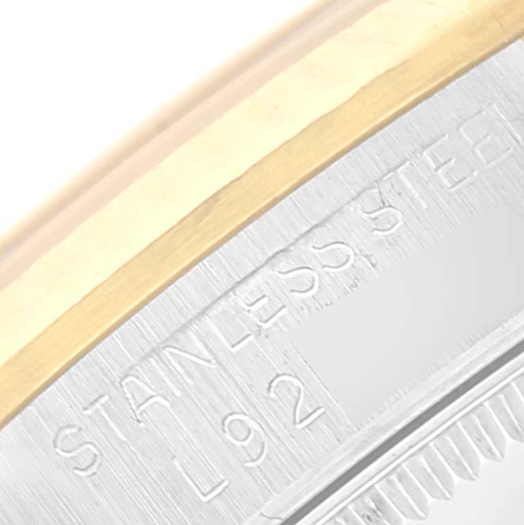 This image shows a close-up of the stainless steel and gold edge of a Rolex Mid-Size 68273 Women
s Steel and Gold (two tone) Black Dial 68273 Women
s Steel and Gold (two tone) Black Dial watch case.