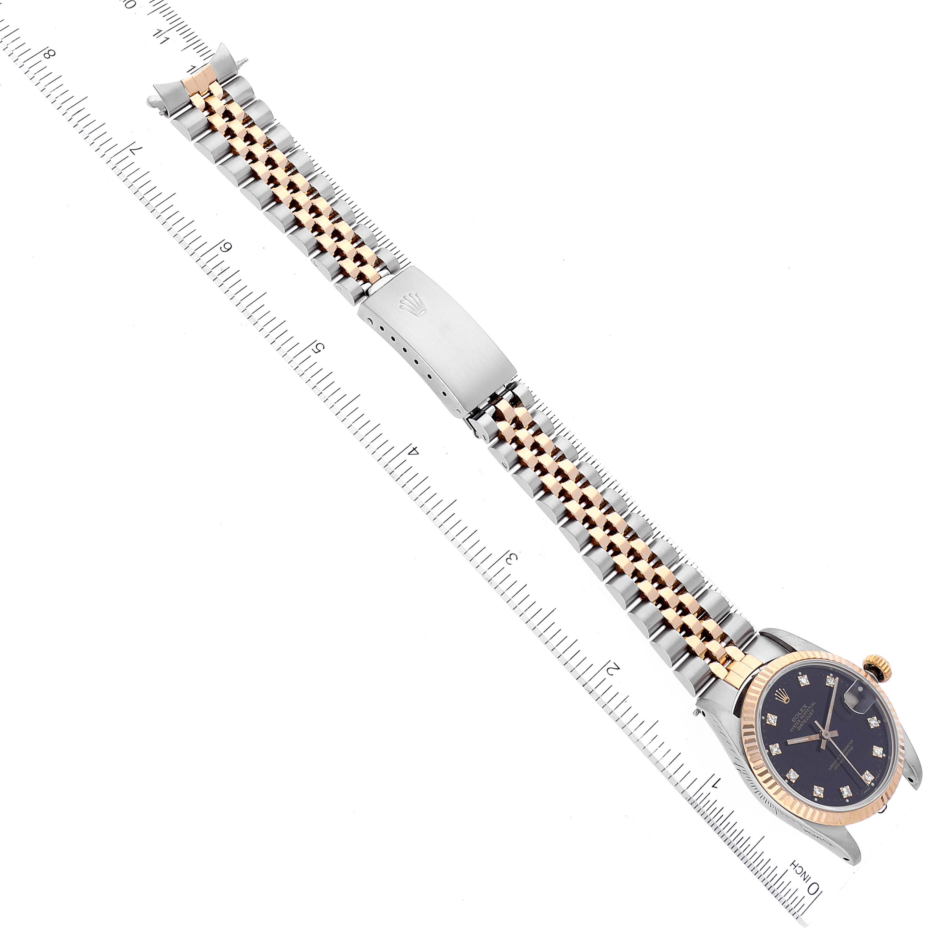 The image shows a Rolex Mid-Size 68273 Women
s Steel and Gold (two tone) Black Dial 68273 Women
s Steel and Gold (two tone) Black Dial watch laid flat with a gold and silver bracelet and a black dial facing up.