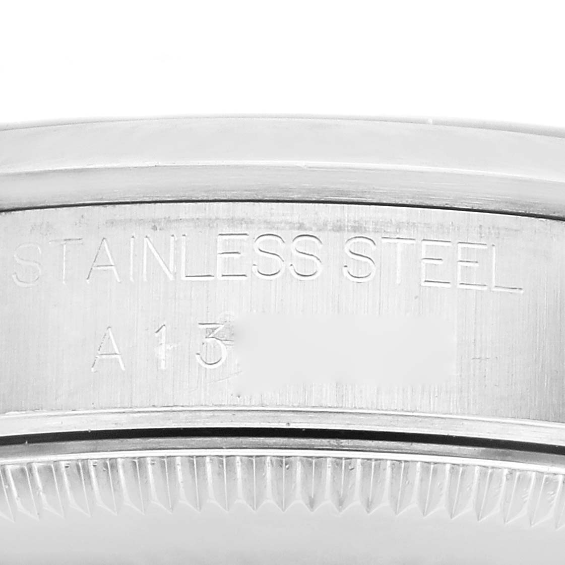 This image shows a close-up of the stainless steel casing with engraved text of a Rolex Mid-Size 68240 Women
s Stainless Steel White Dial 68240 Women
s Stainless Steel White Dial model watch.