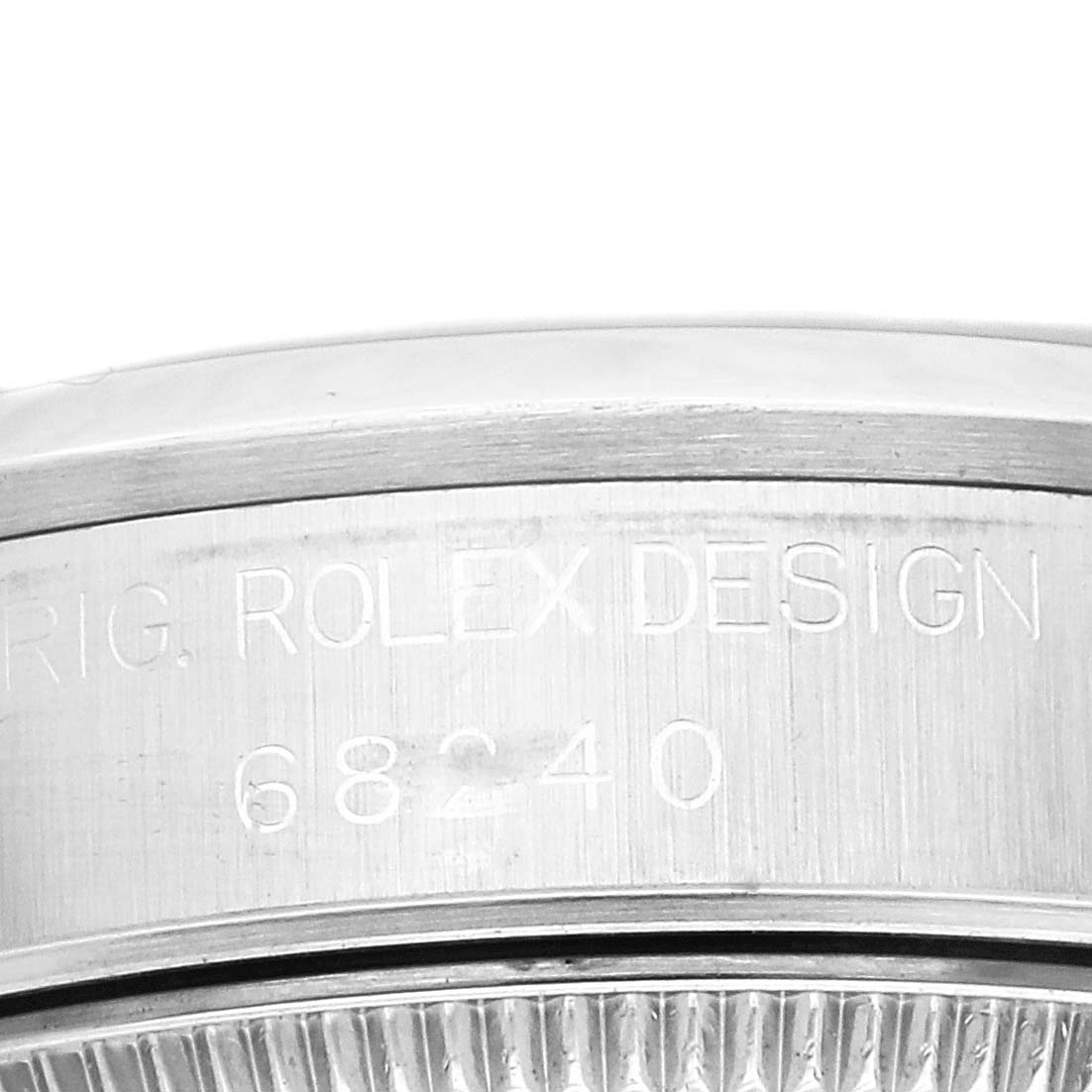 The image shows a close-up of the side of a Rolex Mid-Size 68240 Women
s Stainless Steel White Dial 68240 Women
s Stainless Steel White Dial model, focusing on the engraved details and model number.