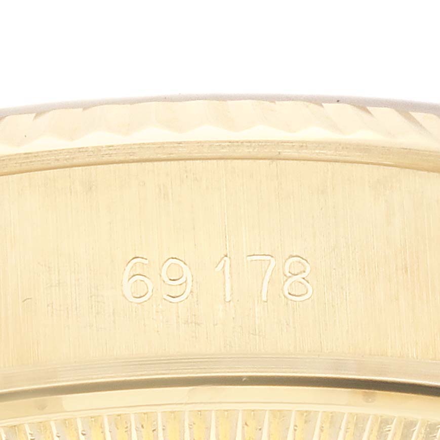This close-up image shows the side of the bezel of a Rolex President 69178 Women
s Yellow Gold Champagne Dial 69178 Women
s Yellow Gold Champagne Dial model watch, highlighting the engraved numbers "69178."