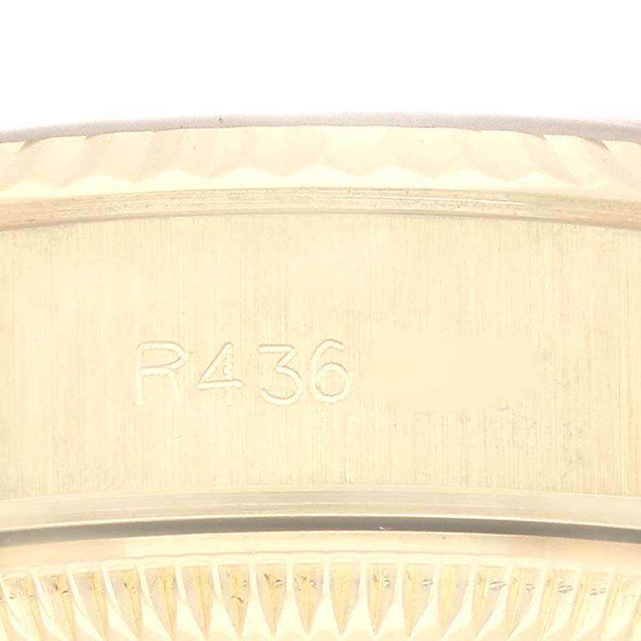 The image shows a close-up of the side of a Rolex President 69178 Women
s Yellow Gold Champagne Dial 69178 Women
s Yellow Gold Champagne Dial model watch with engraved numbers.