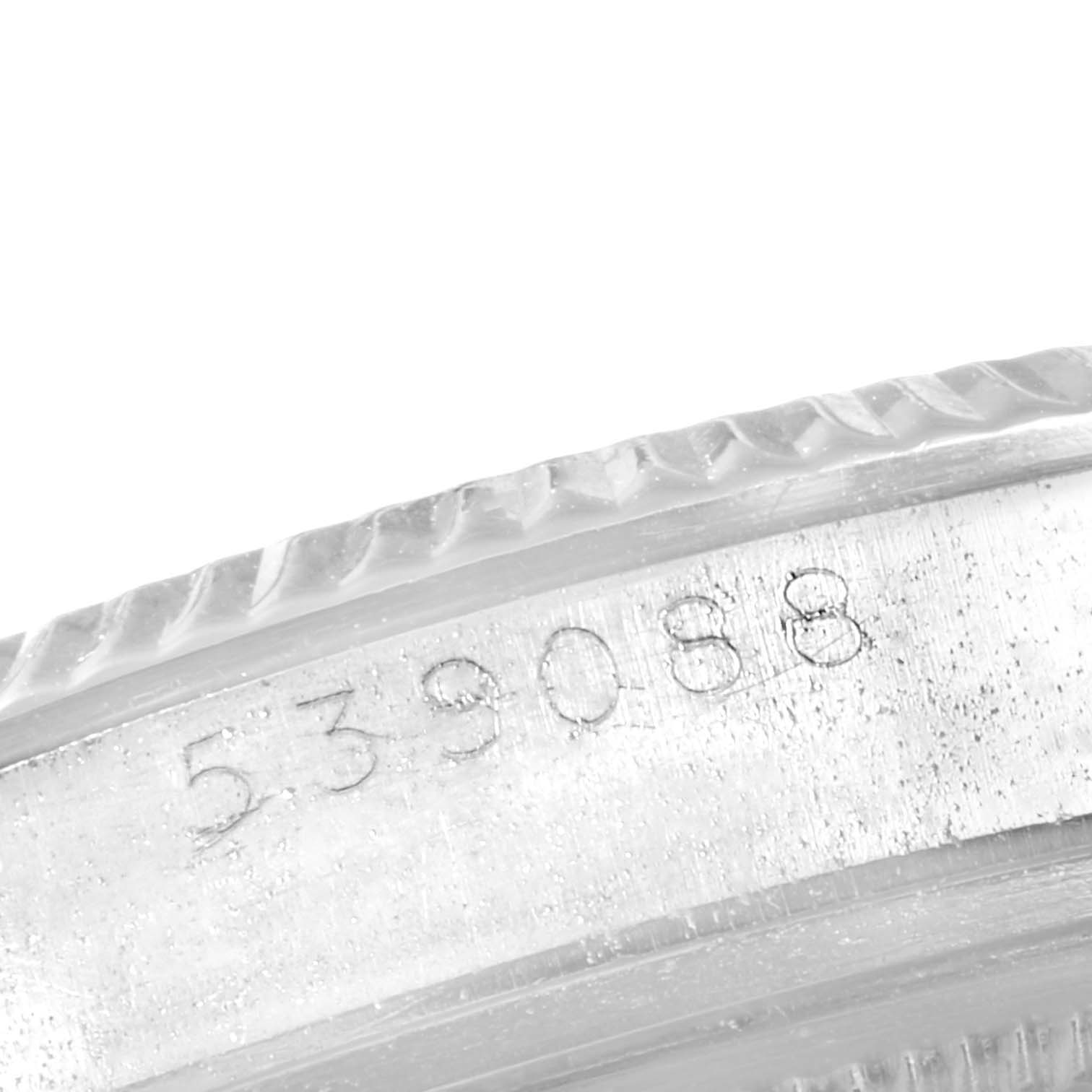 The image shows a close-up angle of the serial number engraved on the side of the Rolex Vintage Collection 1601 Men
s Stainless Steel Silver Dial 1601 Men
s Stainless Steel Silver Dial watch bezel.
