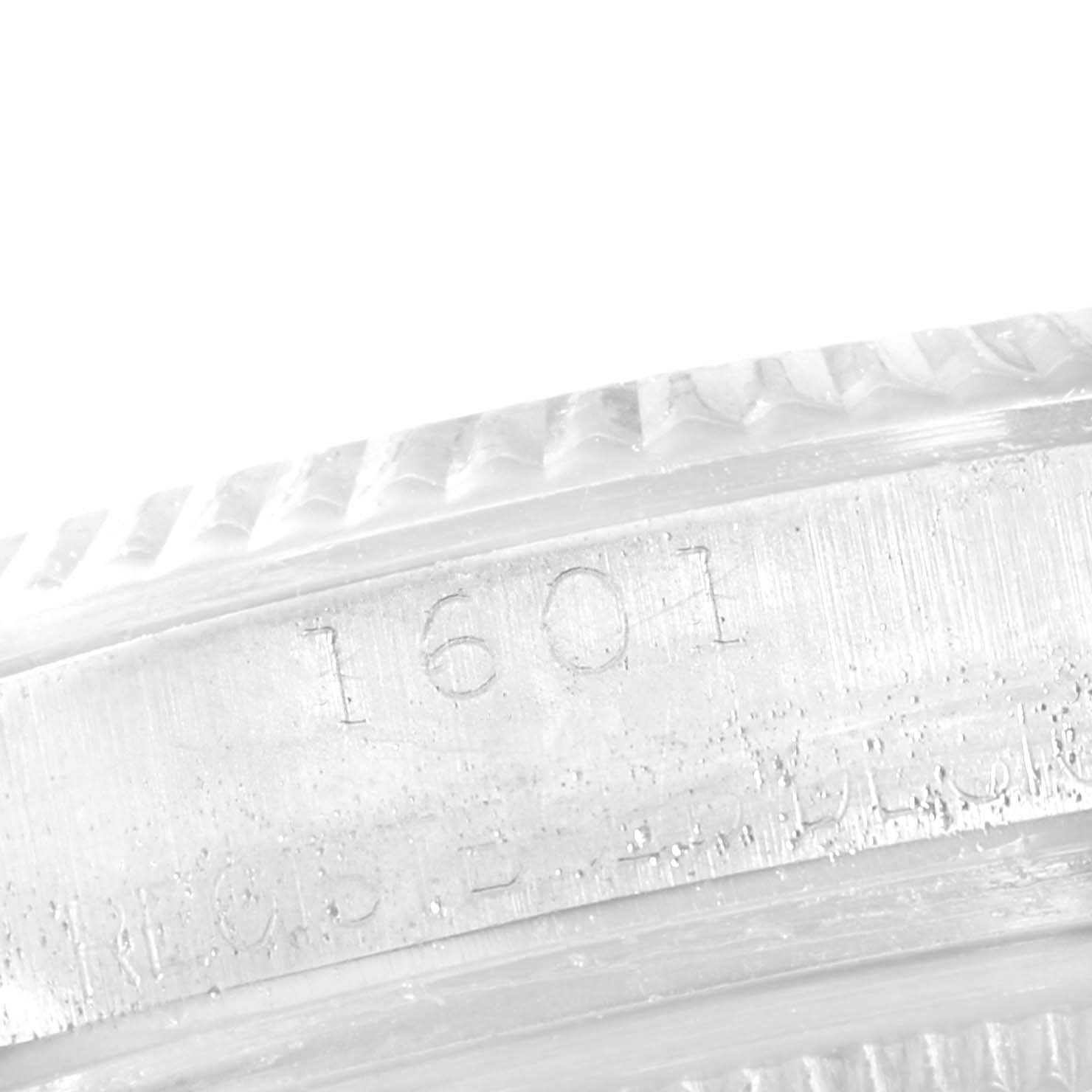 This image shows a close-up of the bezel and model number engraving (1601) of a Vintage Collection Rolex watch.