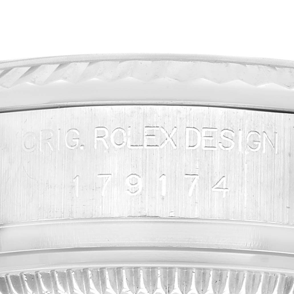 The image shows a close-up of the engraved serial and model number on the side of a Datejust Rolex watch case.