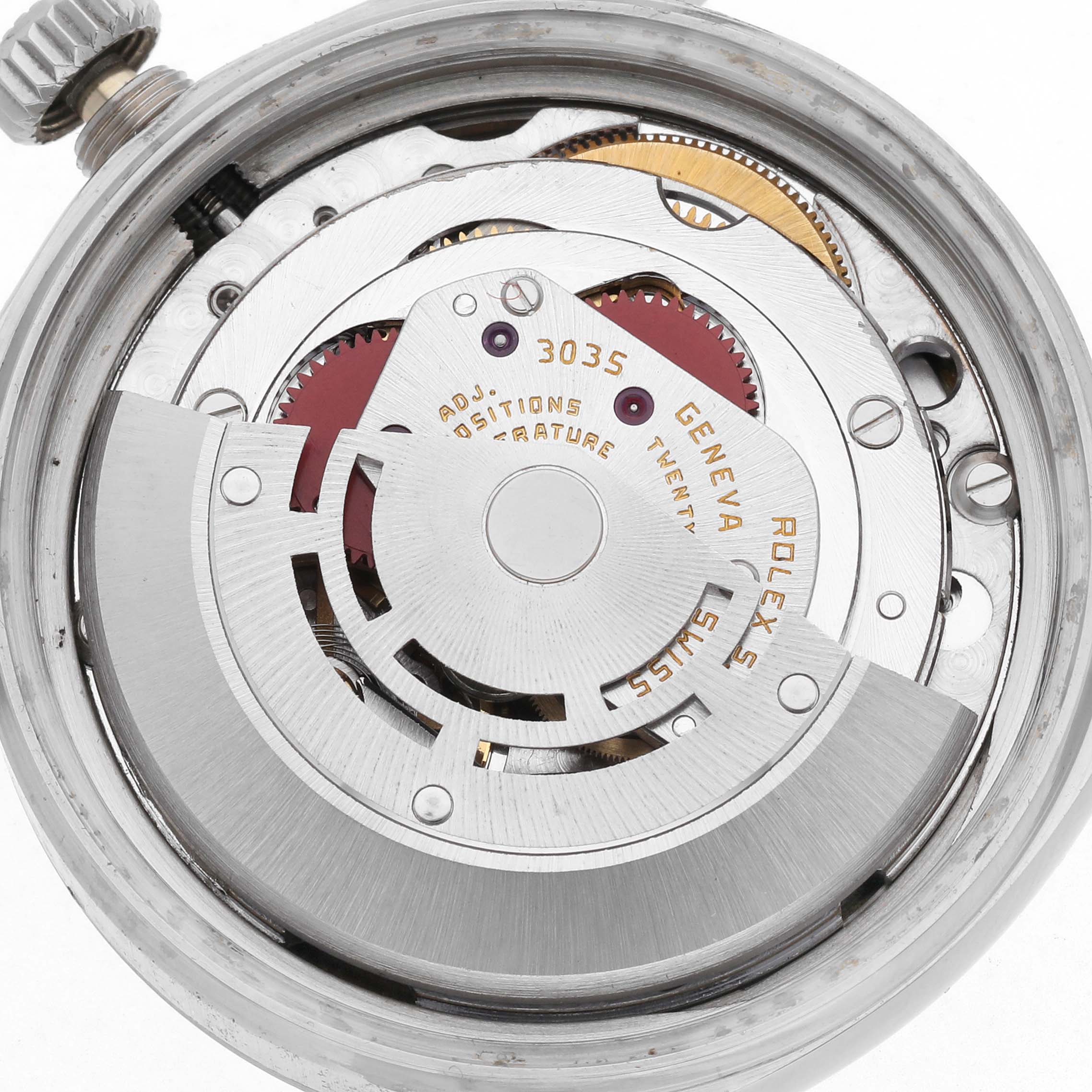 The image shows a close-up of the movement inside a Rolex Datejust 16014 Men's Stainless Steel White Dial 16014 Men's Stainless Steel White Dial model, highlighting gears and the oscillating weight.