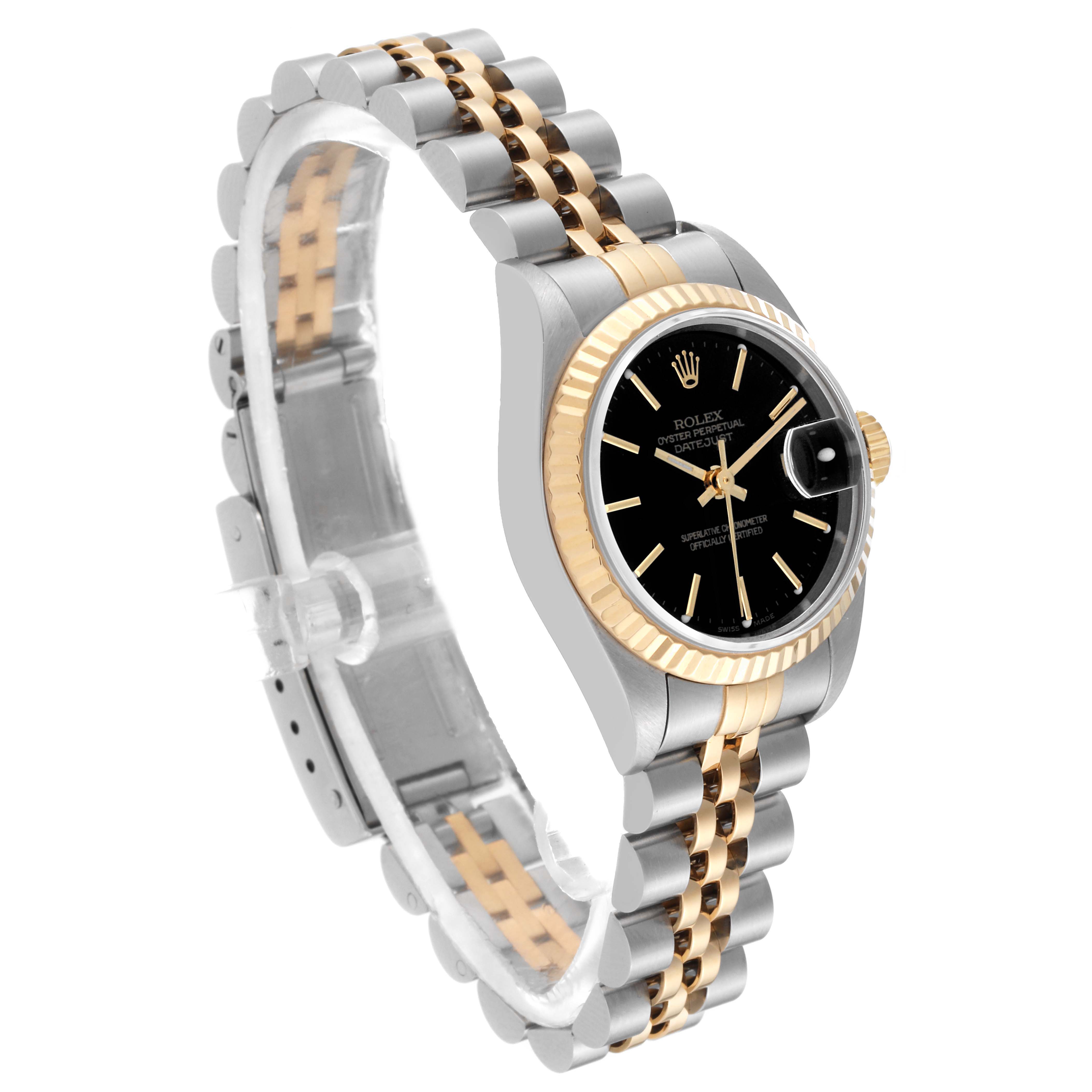 The image shows a Rolex Datejust 79173 Women's Steel and Gold (two tone) Black Dial 79173 Women's Steel and Gold (two tone) Black Dial watch at an oblique angle, highlighting its black dial, fluted bezel, and two-tone bracelet.