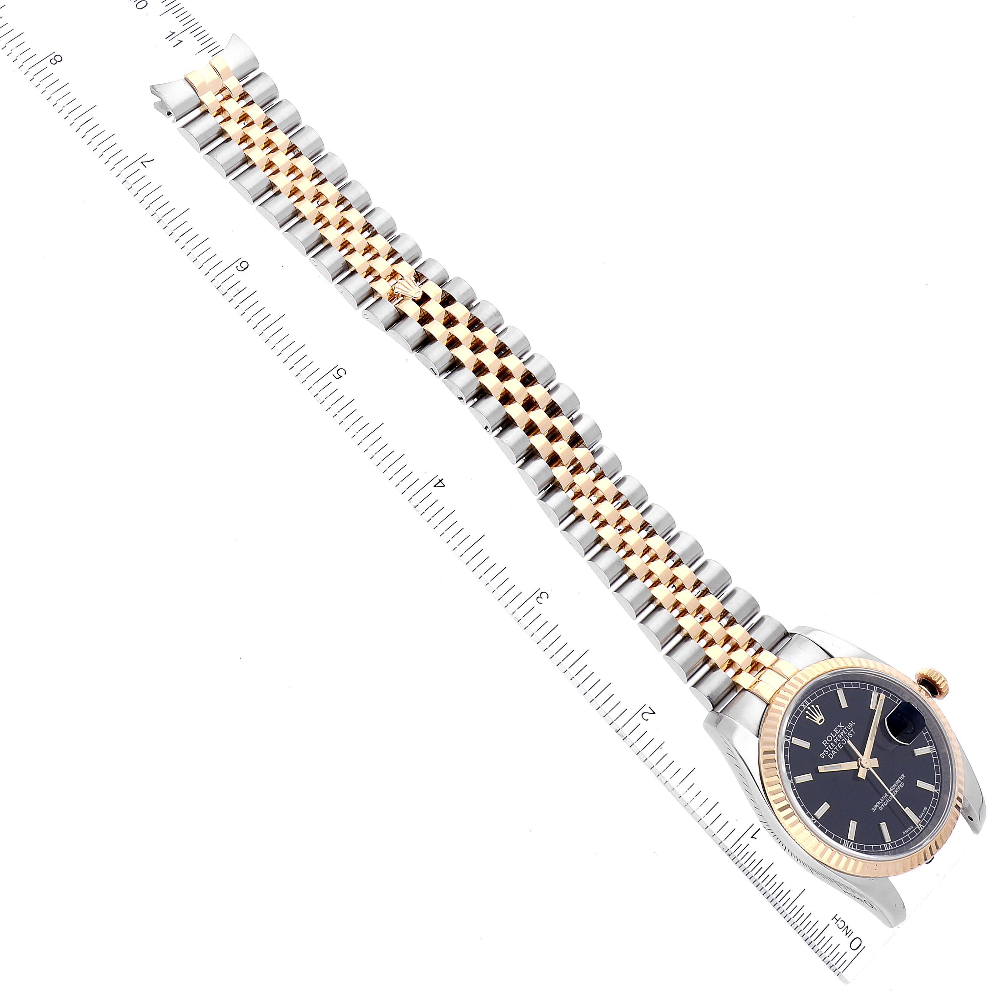The image shows a Rolex Datejust 116233 Men's Steel and Gold (two tone) Black Dial 116233 Men's Steel and Gold (two tone) Black Dial watch flat-laid with a full view of the dial, case, bracelet, and a measuring ruler.