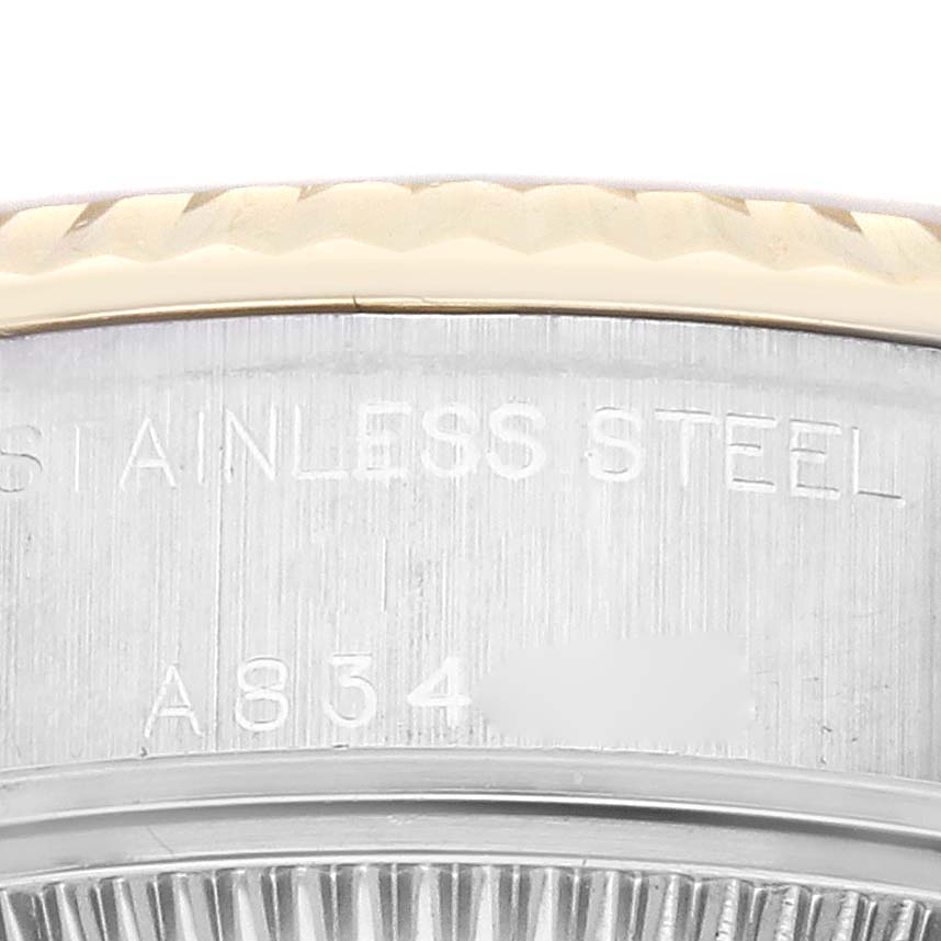 This image shows a close-up of the Rolex Datejust 79173 Women's Steel and Gold (two tone) Champagne Dial 79173 Women's Steel and Gold (two tone) Champagne Dial watch's stainless steel case back with partial serial number engraving.