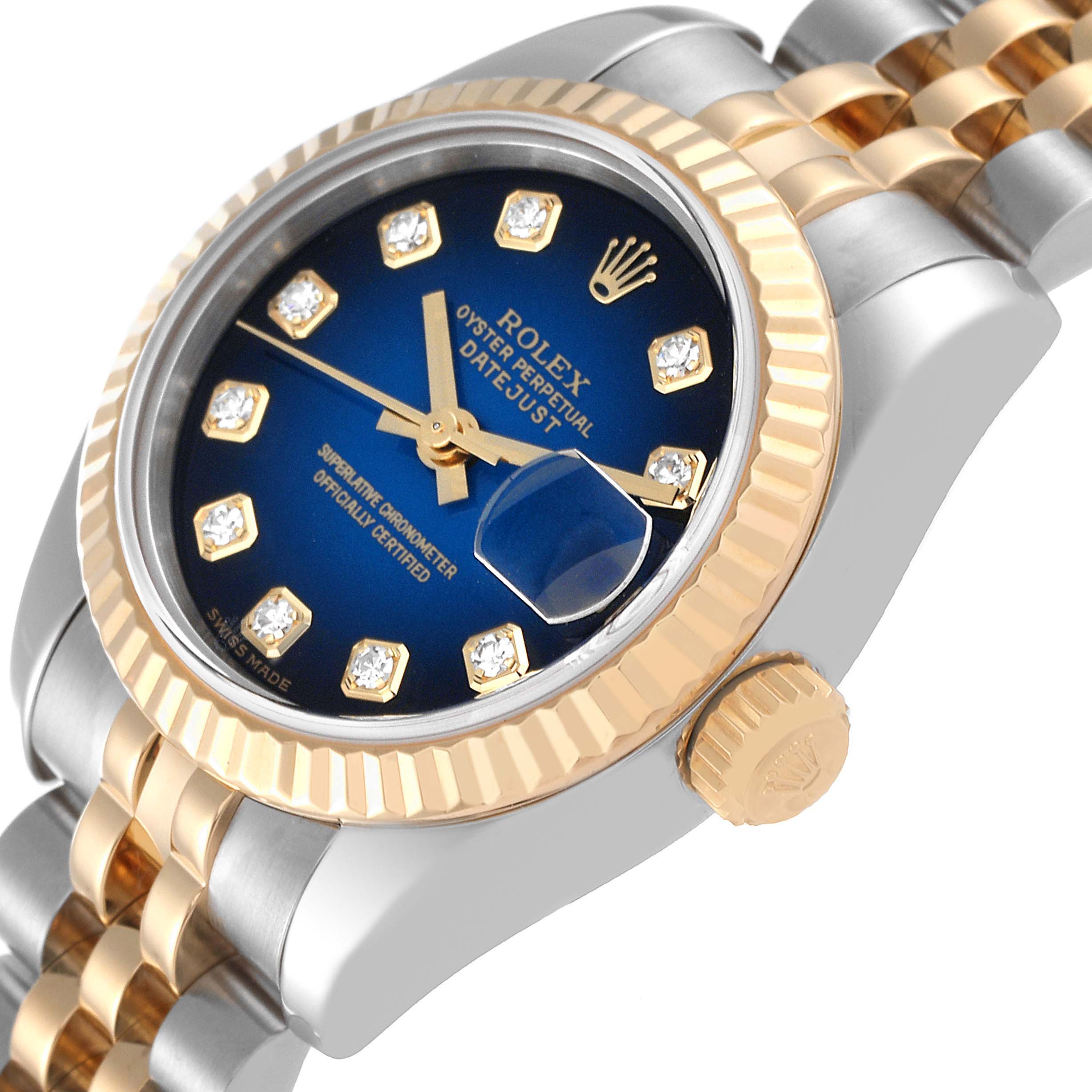 The image shows a side angle of the Rolex Datejust 179173 Women's Steel and Gold (two tone) Blue Dial 179173 Women's Steel and Gold (two tone) Blue Dial watch highlighting the crown, bezel, dial, and a portion of the bracelet.