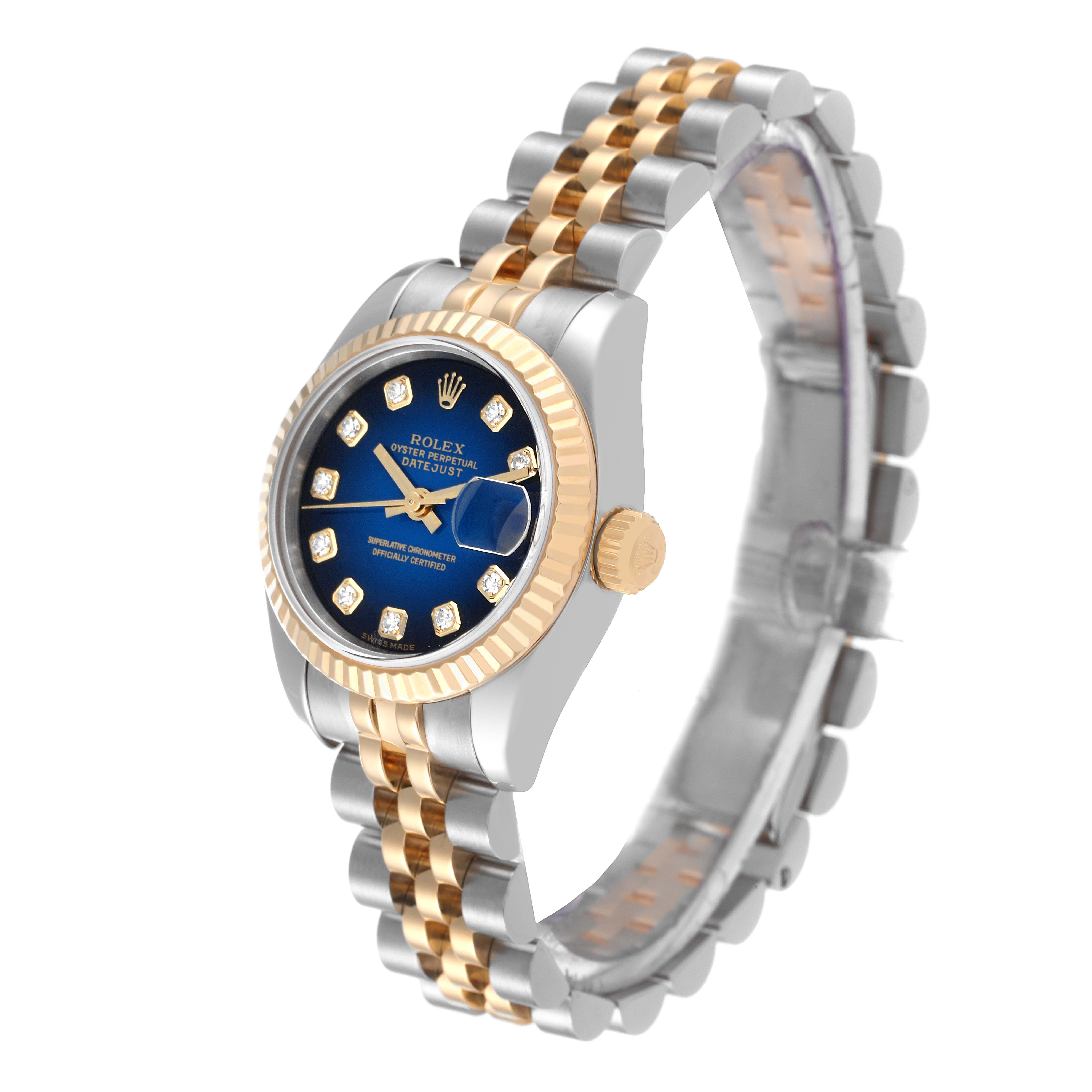 The image shows a Rolex Datejust 179173 Women's Steel and Gold (two tone) Blue Dial 179173 Women's Steel and Gold (two tone) Blue Dial watch at an angled view, highlighting its two-tone bracelet, blue dial, and fluted bezel.