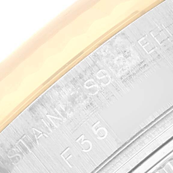 The image shows a close-up of the bezel and engraved text on the side of the Rolex Datejust 179173 Women's Steel and Gold (two tone) Blue Dial 179173 Women's Steel and Gold (two tone) Blue Dial watch.