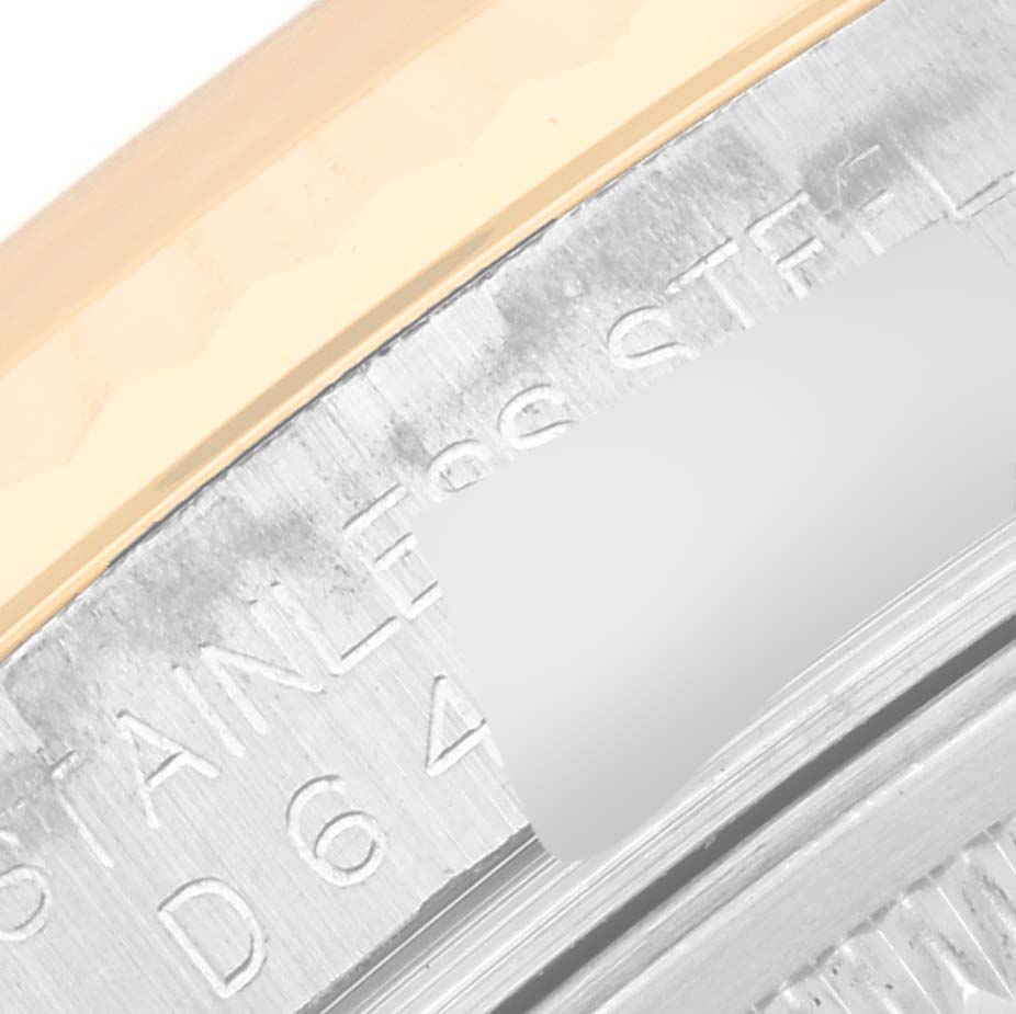 This close-up shows part of the casing and inscription details of a Rolex Datejust 116233 Men's Steel and Gold (two tone) Beige Dial 116233 Men's Steel and Gold (two tone) Beige Dial model watch.