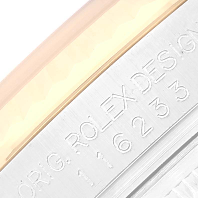This image shows a close-up of the engraved text on the side of a Rolex Datejust 116233 Men's Steel and Gold (two tone) Beige Dial 116233 Men's Steel and Gold (two tone) Beige Dial watch case.
