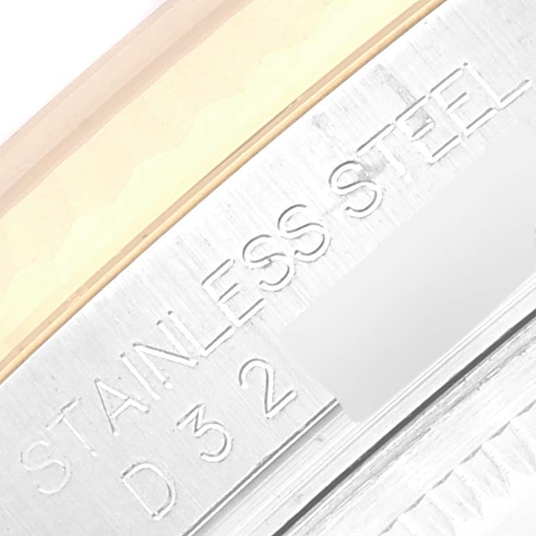 The image shows a close-up of the case edge of a Rolex Datejust 116233 Men's Steel and Gold (two tone) Beige Dial 116233 Men's Steel and Gold (two tone) Beige Dial model watch with "STAINLESS STEEL" and part of a serial number engraved.