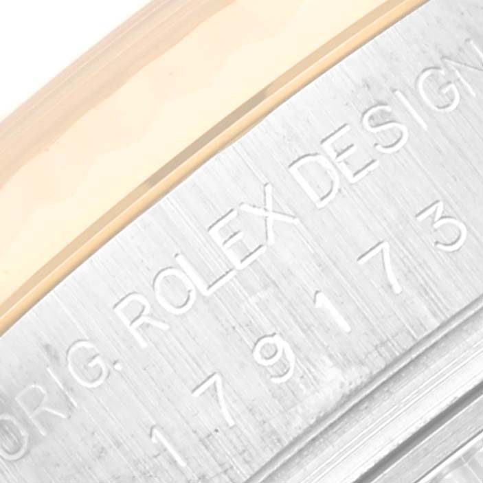 The image shows a close-up angle of the engraving on the casing for a Rolex Datejust 179173 Women's Steel and Gold (two tone) White Dial 179173 Women's Steel and Gold (two tone) White Dial watch.