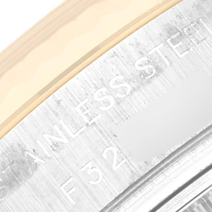 Close-up of the side of a Rolex Datejust 179173 Women's Steel and Gold (two tone) White Dial 179173 Women's Steel and Gold (two tone) White Dial watch showing part of the stainless steel case with engravings.